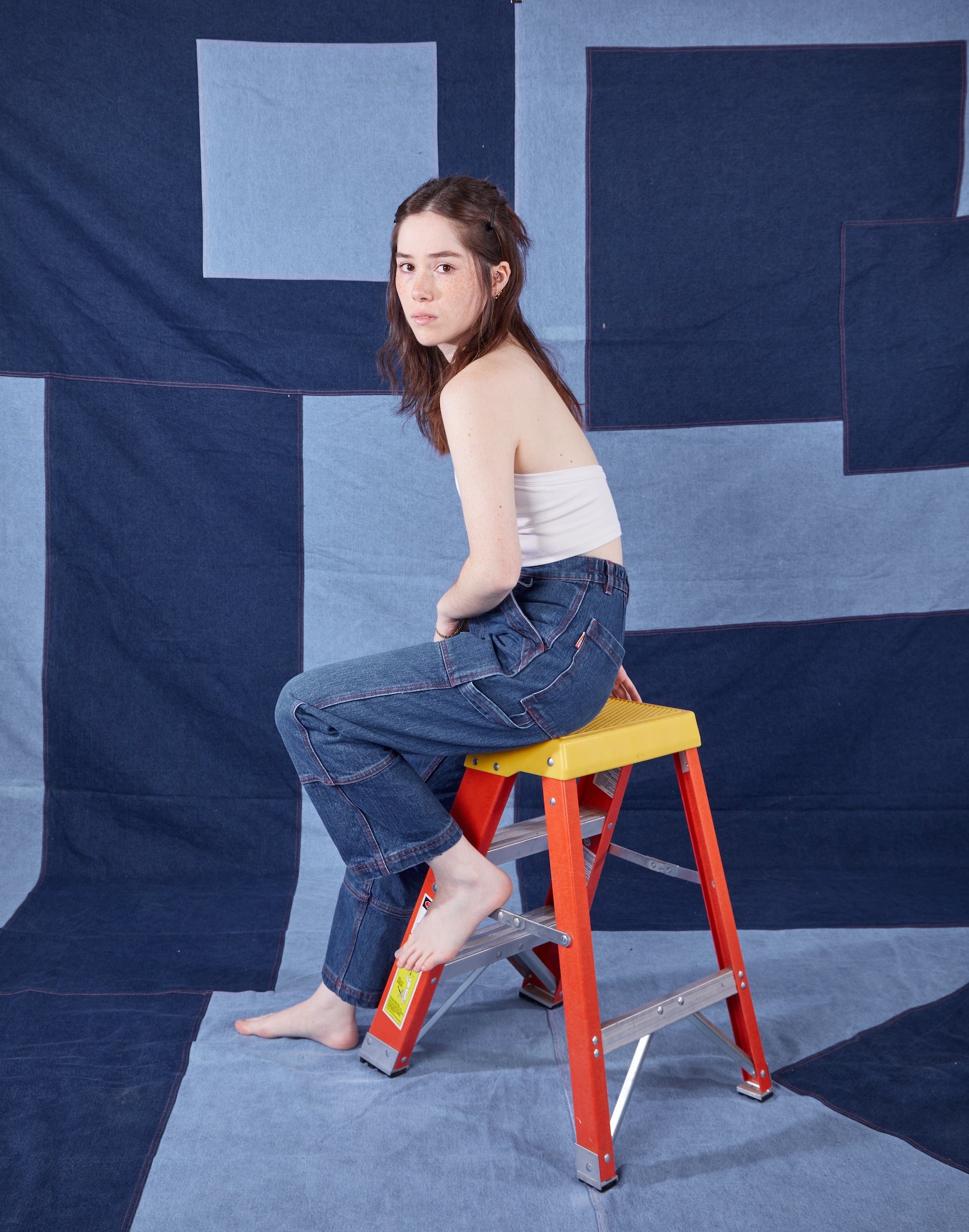 Hana is wearing Petite Carpenter Jeans in Dark Wash and Halter Top in Vintage Off-White