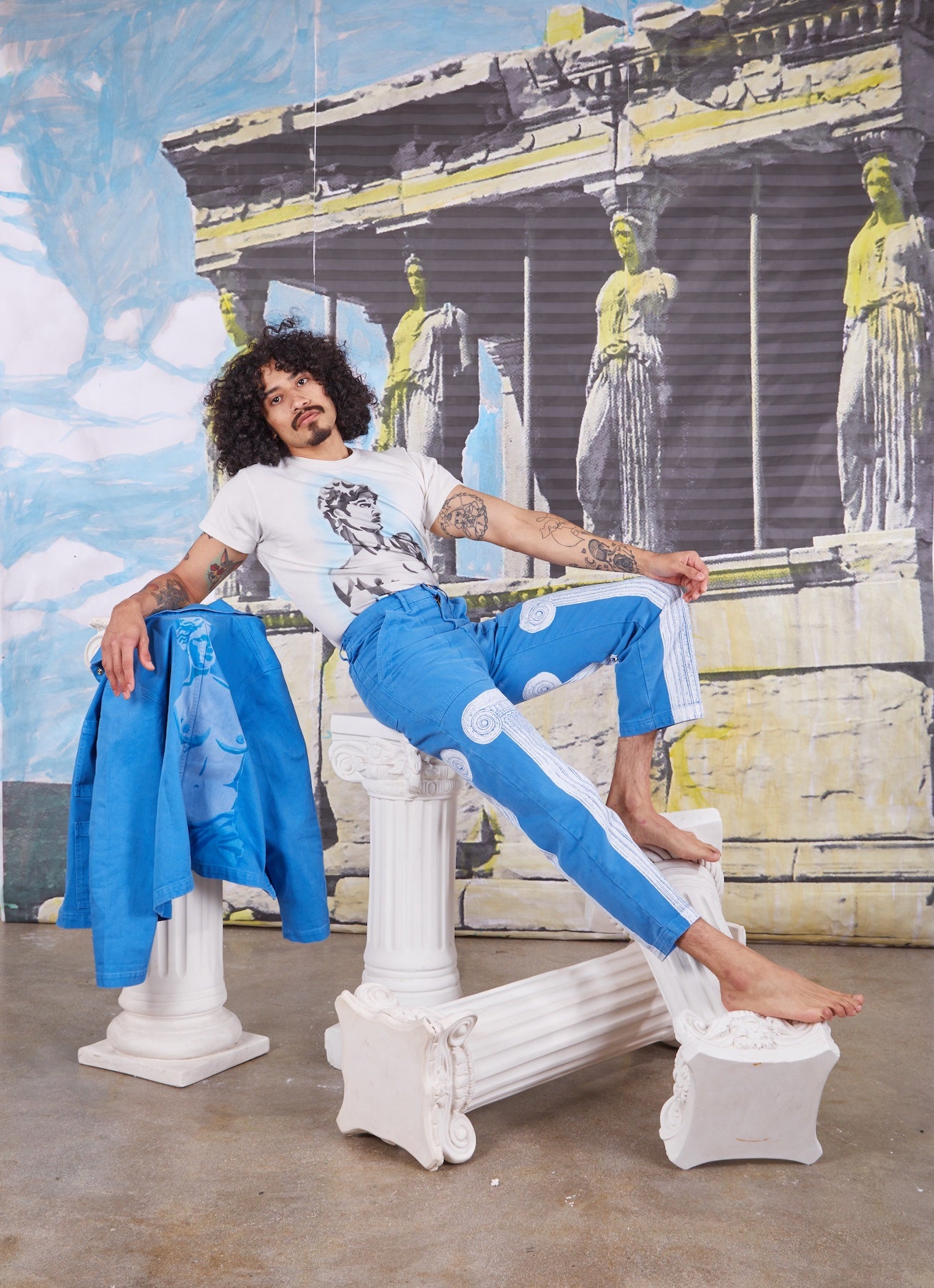 Jesse is wearing David Airbrushed Organic Tee with Paintstamped Column Work Pants