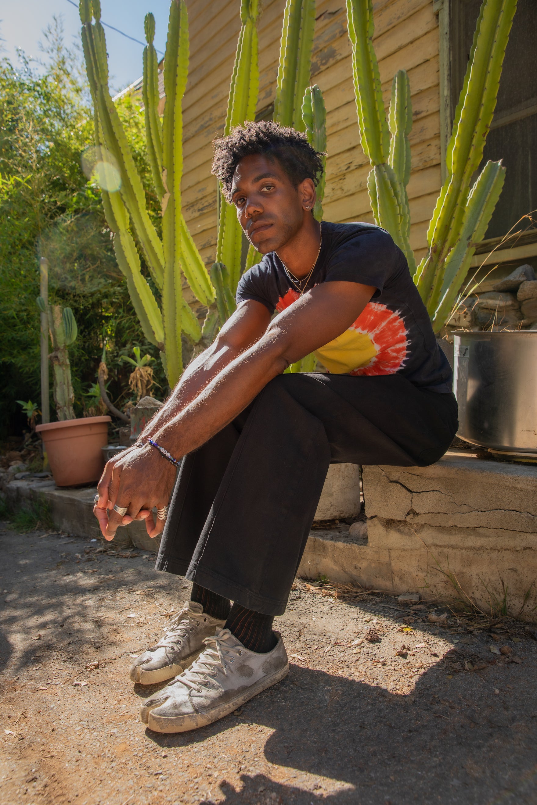 Jerrod wearing Tie Dye Tee in Black Eclipse and Western Pants in Basic Black