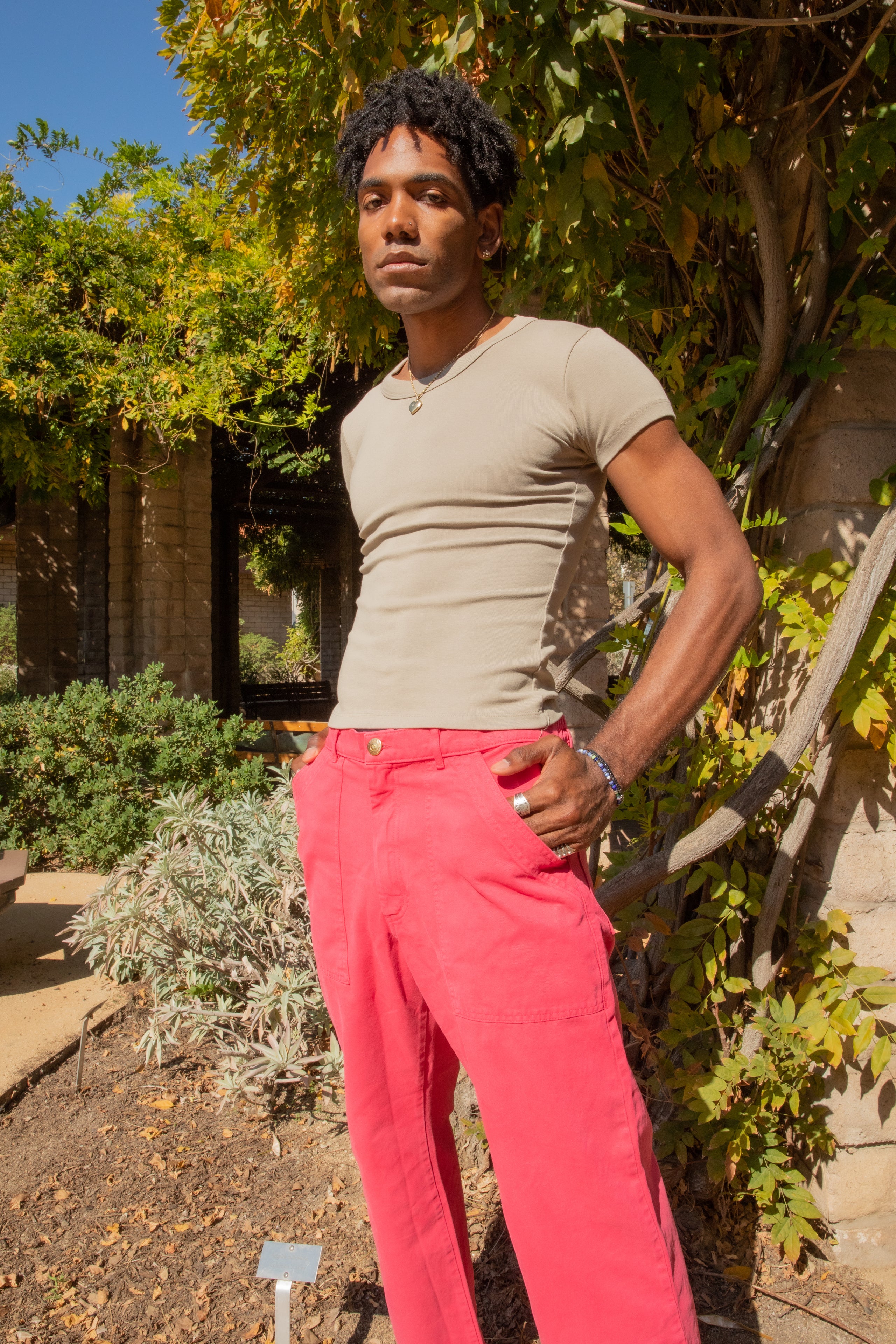 Jerrod wearing Work Pants in Hot Pink and Baby Tee in Khaki Grey