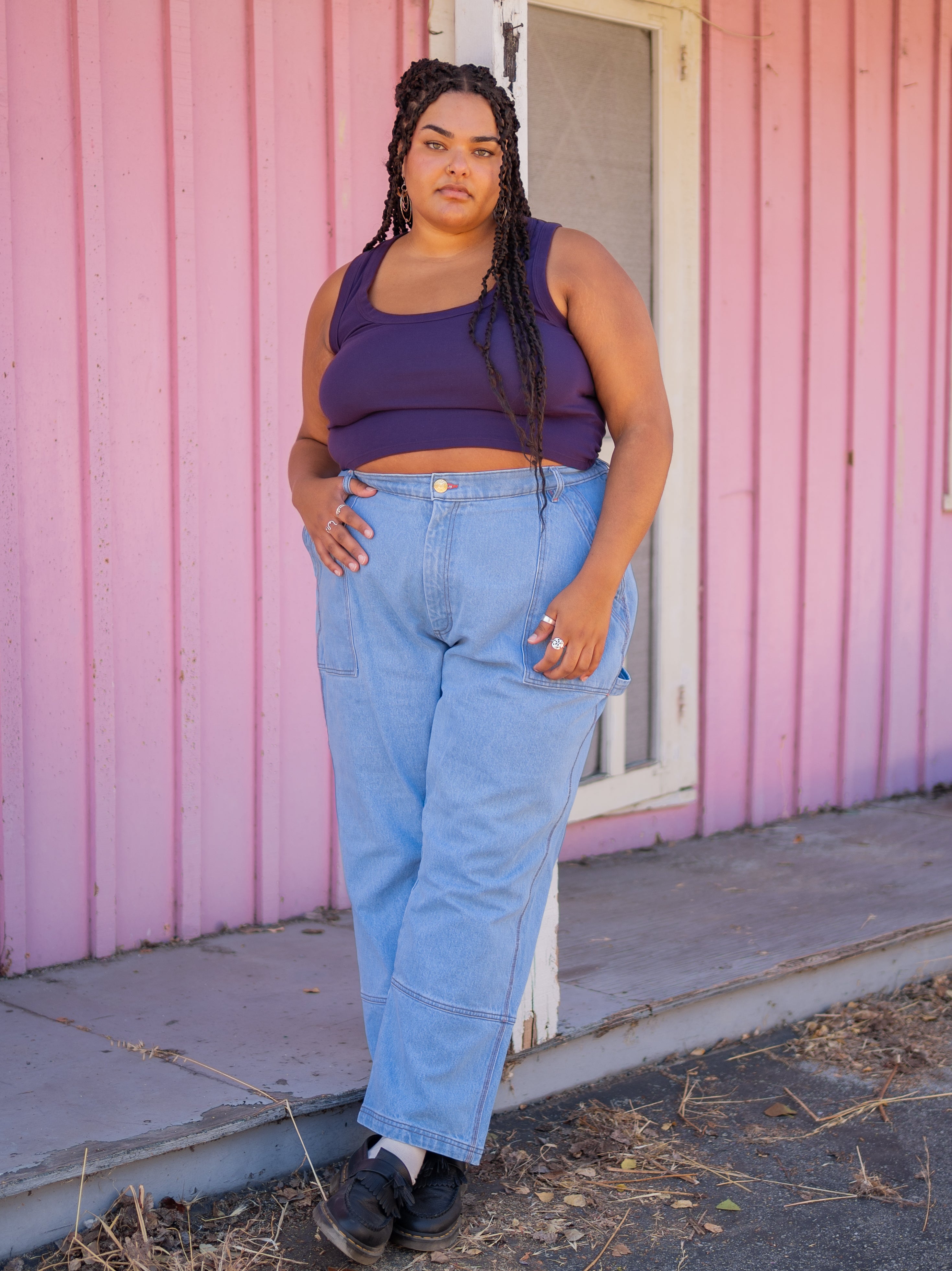 Alicia is wearing Cropped Tank Top in Nebula and Carpenter Jeans in Light Wash