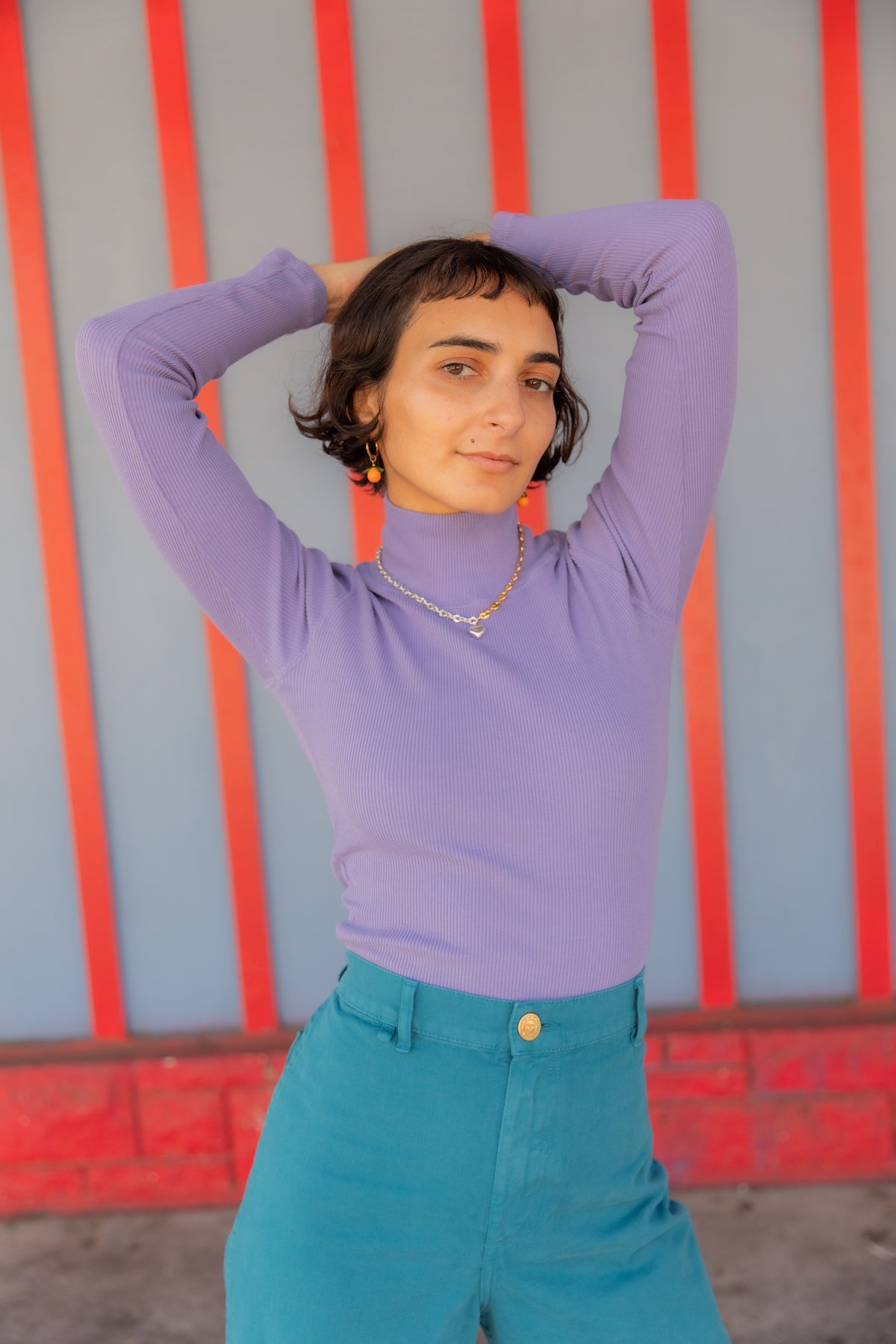Soraya is wearing Petite Bell Bottoms in Marine Blue and Essential Turtleneck in Faded Grape
