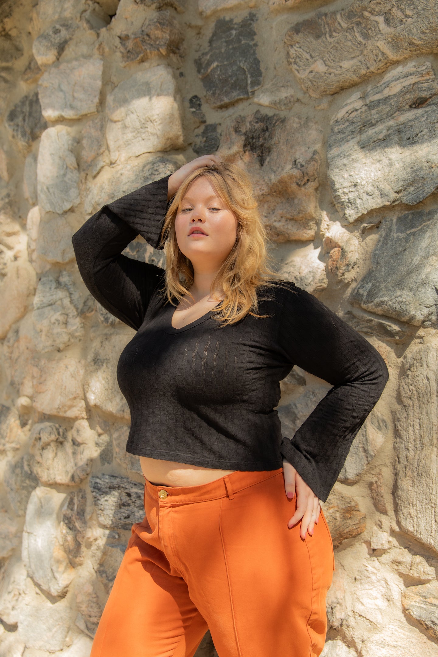 Juliet is wearing Bell Sleeve Top in Basic Black and Western Pants in Burnt Terracotta