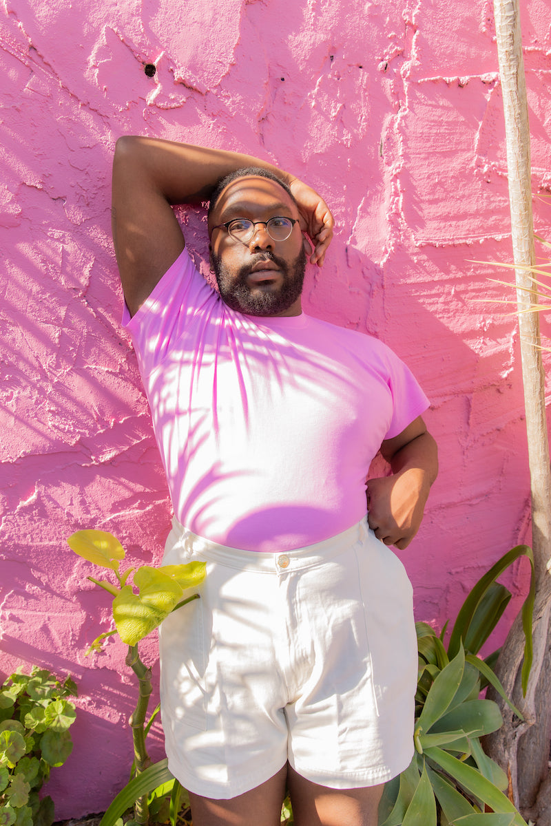 Elijah is wearing Organic Tee in Bubblegum Pink and Work Shorts in Vintage Off-White