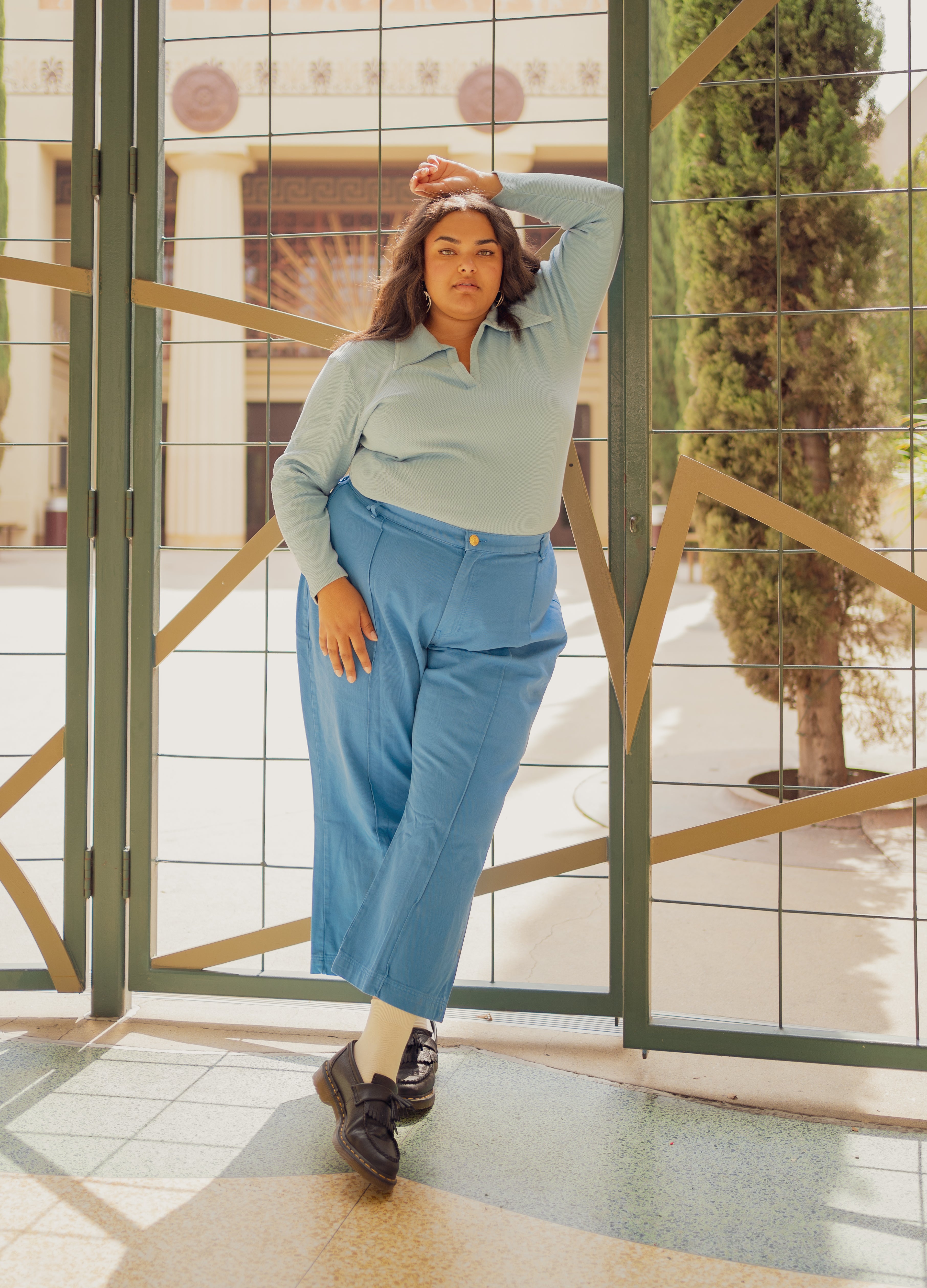 Alicia is wearing Long Sleeve Fisherman Polo in Baby Blue and Western Pants in Greek Blue