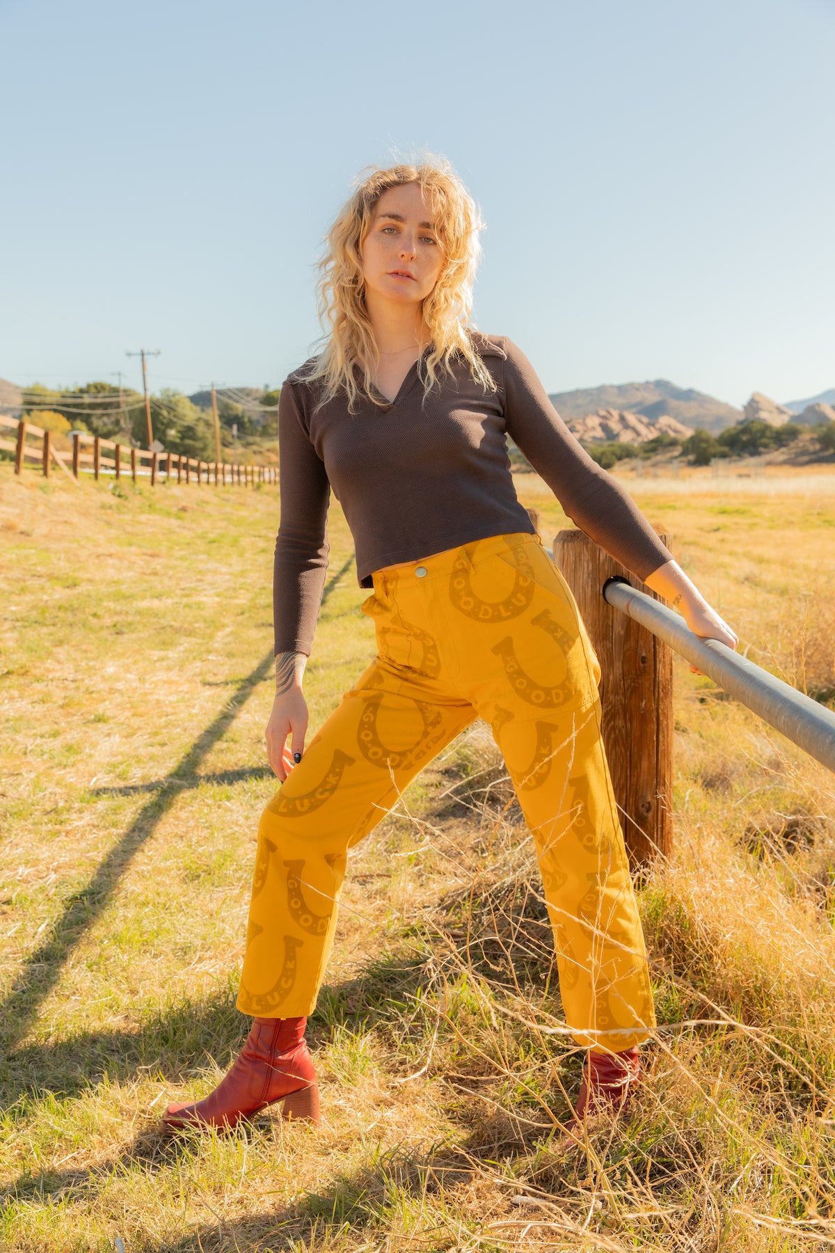 Ada is wearing Long Sleeve Fisherman Polo in Espresso Brown and Icon Work Pants in Golden Horseshoes