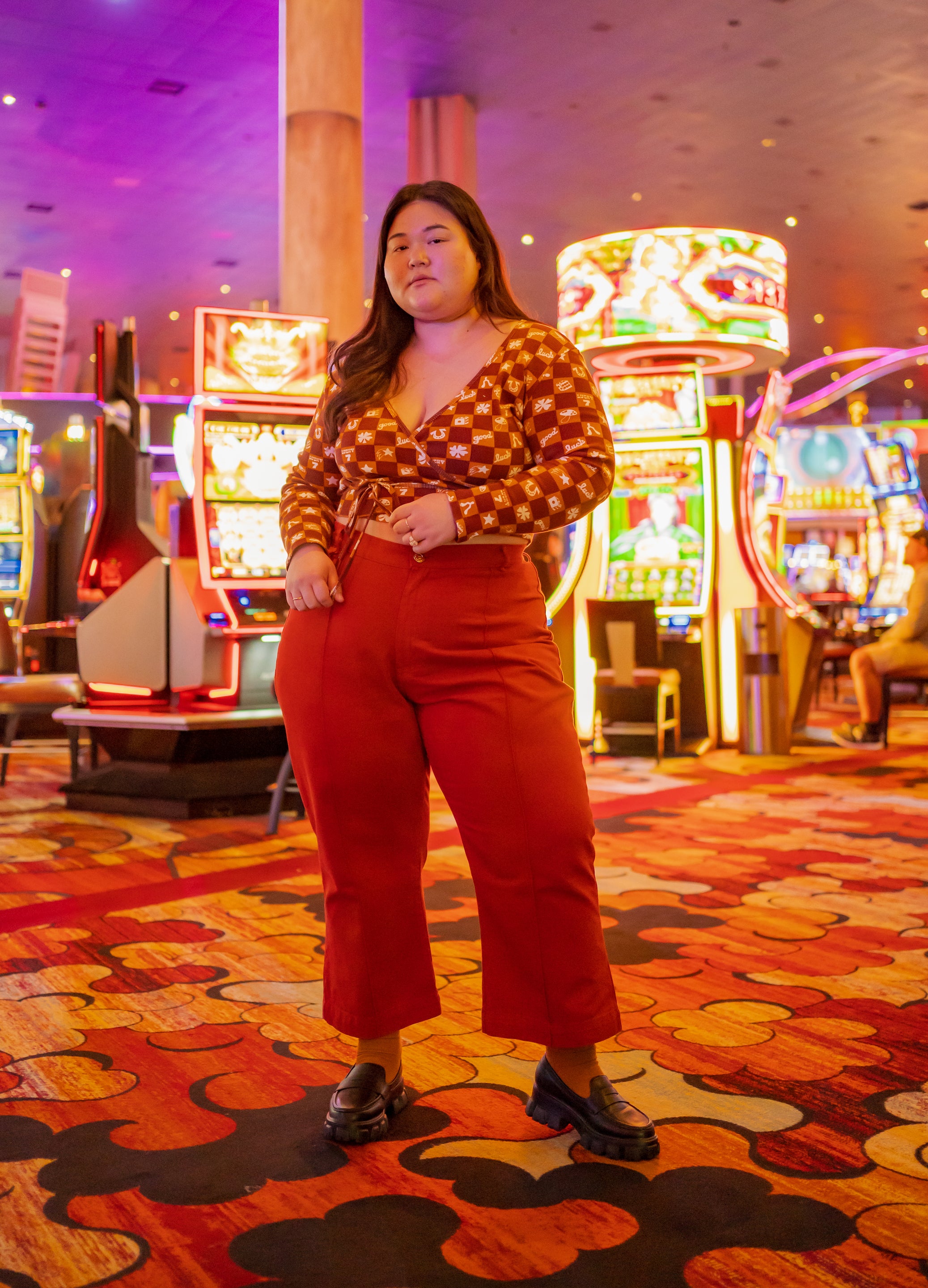 Ashley in casino wearing Lucky Print Wrap Top in Spicy Mustard and Western Pants in Paprika