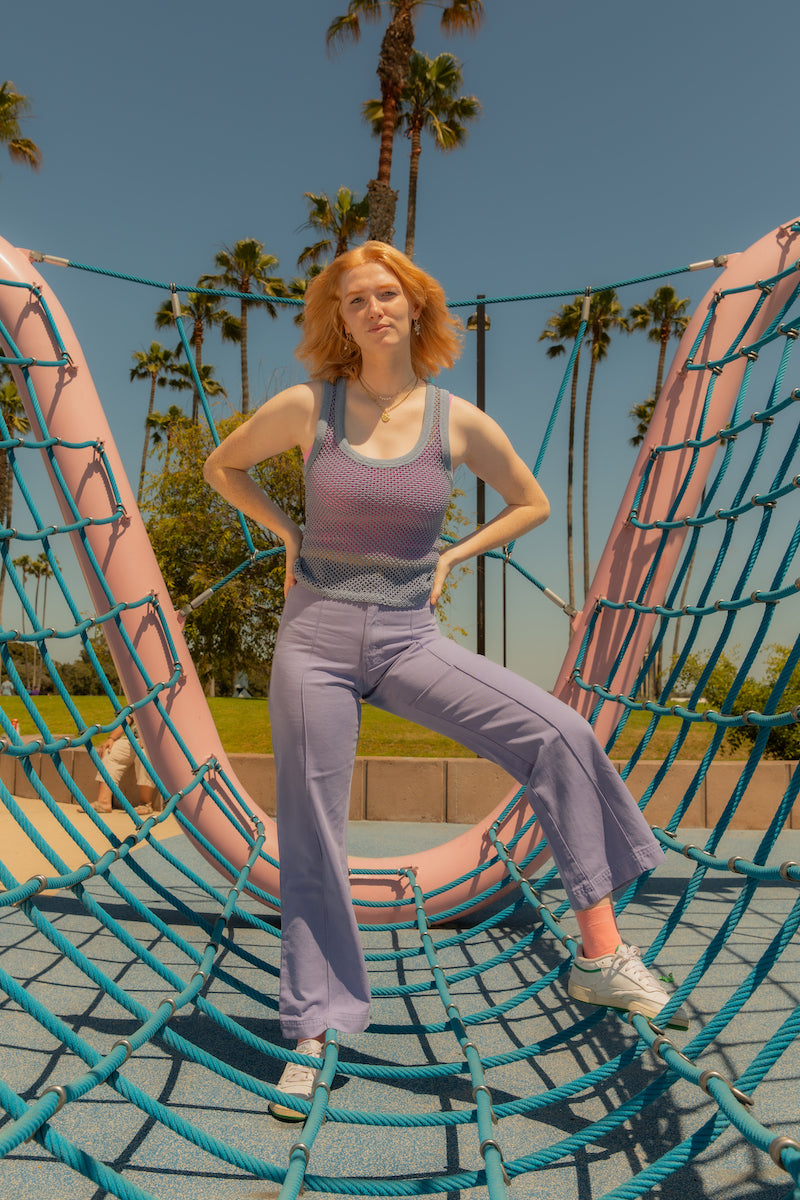 Margaret is wearing Mesh Tank Top in Periwinkle with Cropped Tank Top in Bubblegum Pink underneath and Western Pants in Faded Grape