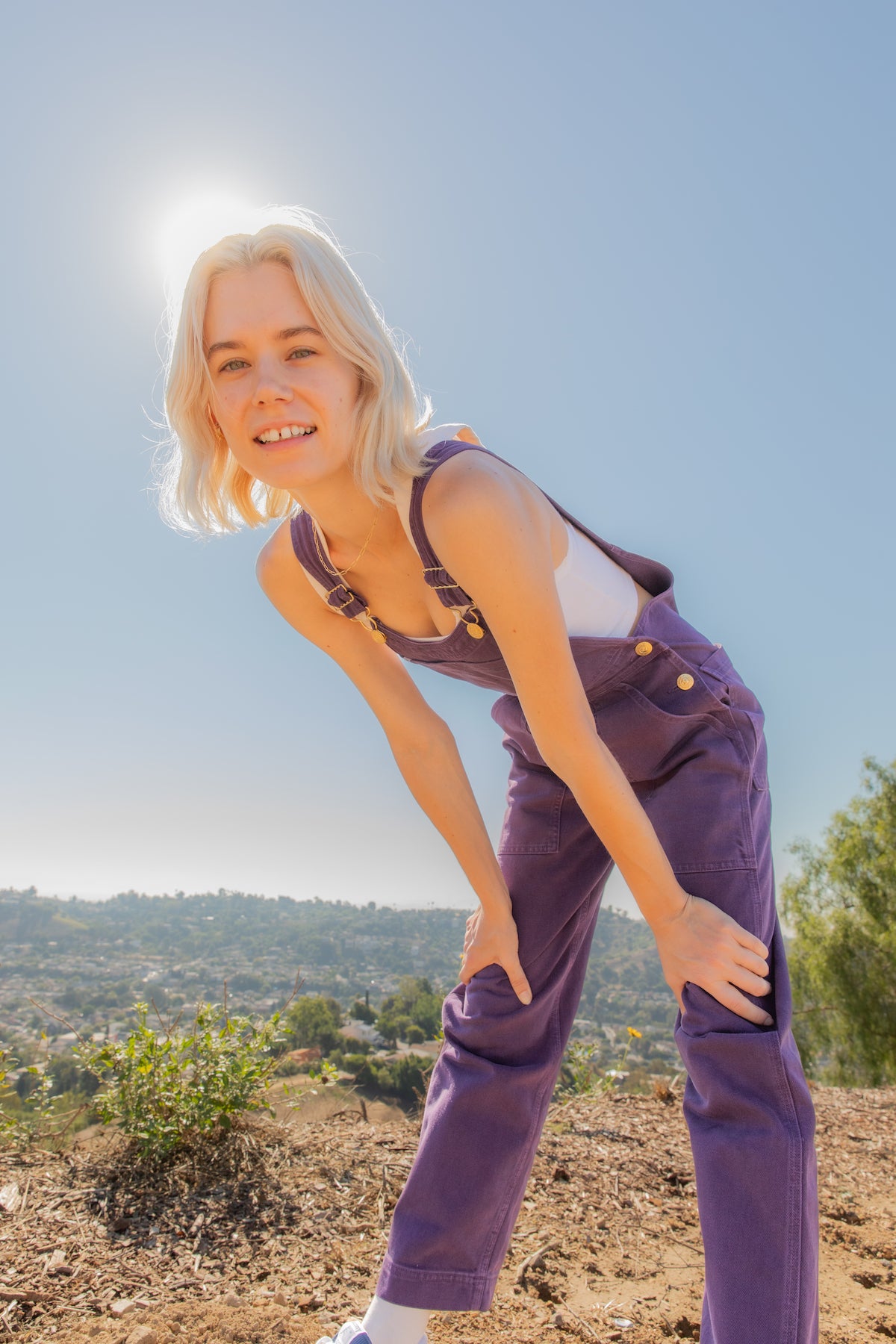 Madeline is wearing Original Overalls in Mono Nebula Purple and Cropped Tank Top in Vintage Off-White