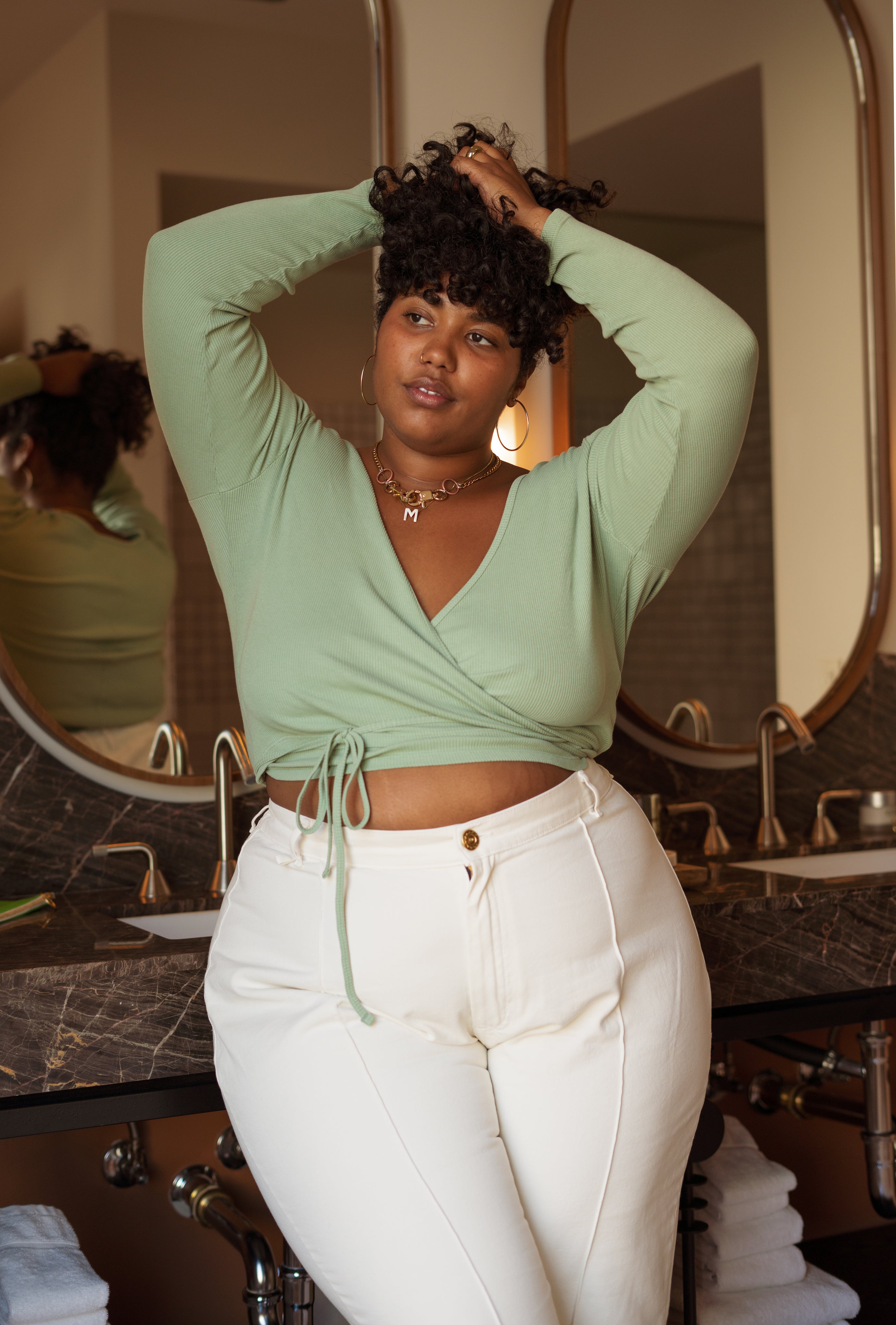 Morgan wearing Wrap Top in Sage Green and Western Pants in Vintage Off-White