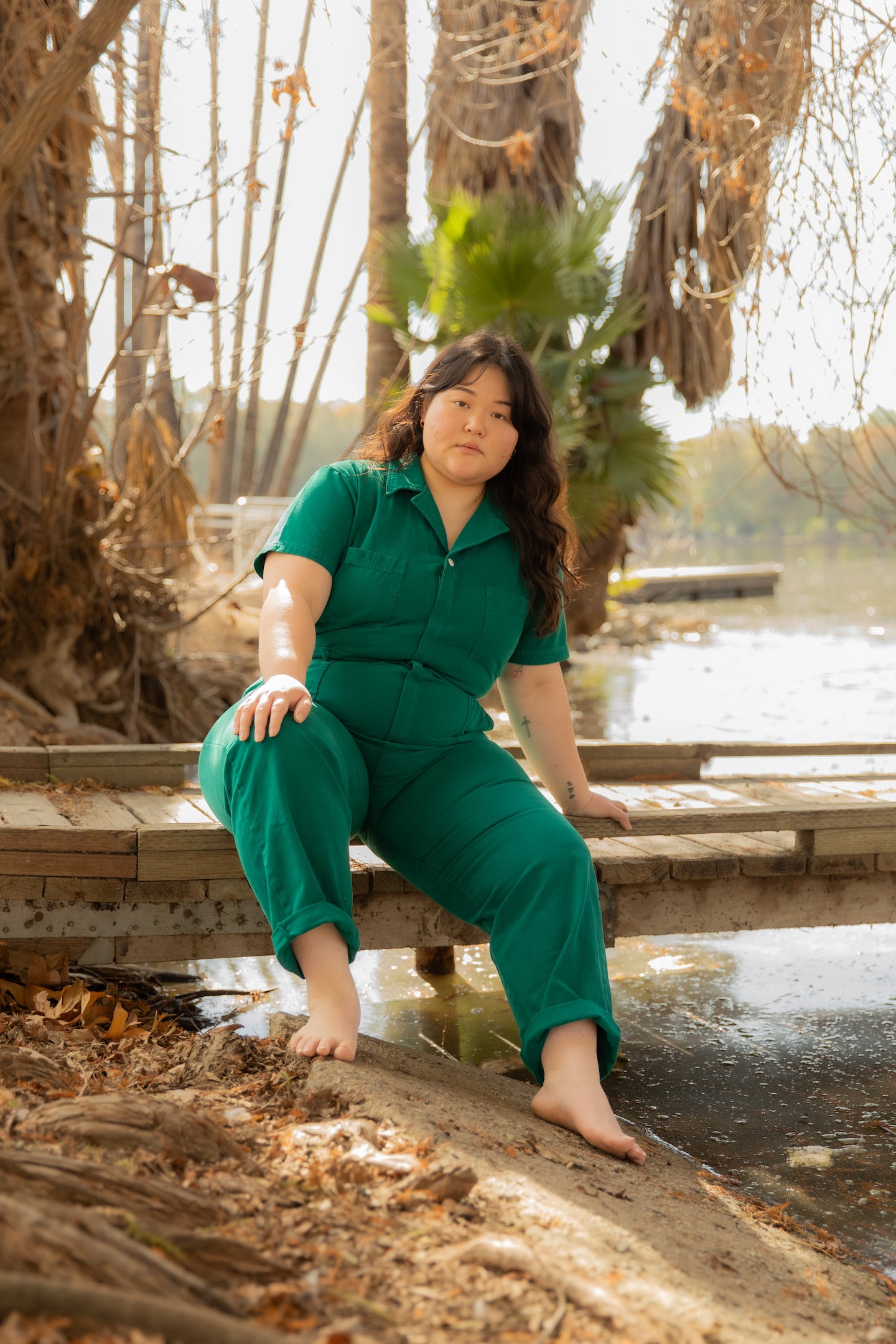 Ashley is wearing the Short Sleeve Jumpsuit in Hunter Green