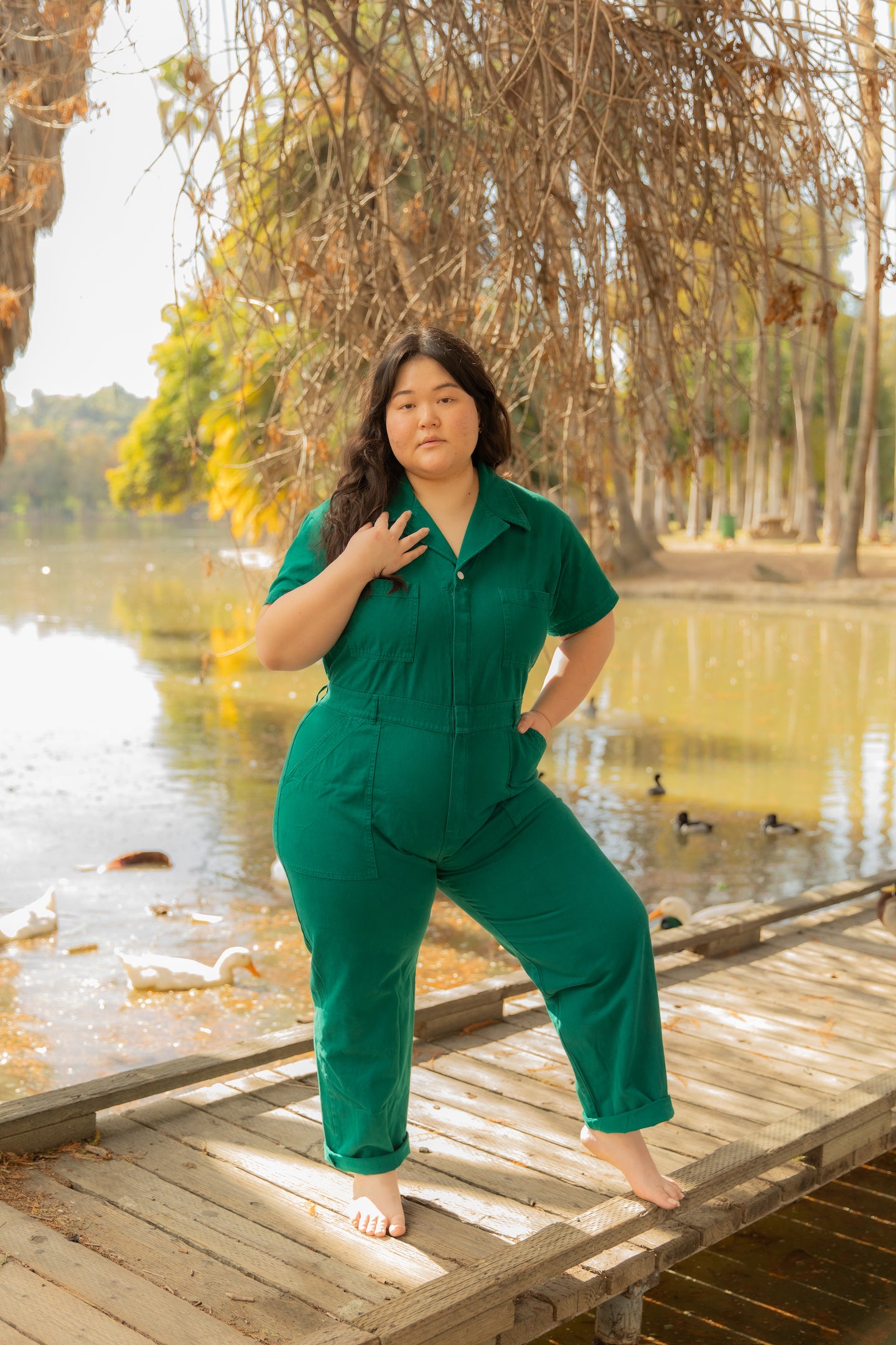 Ashley is wearing the Short Sleeve Jumpsuit in Hunter Green