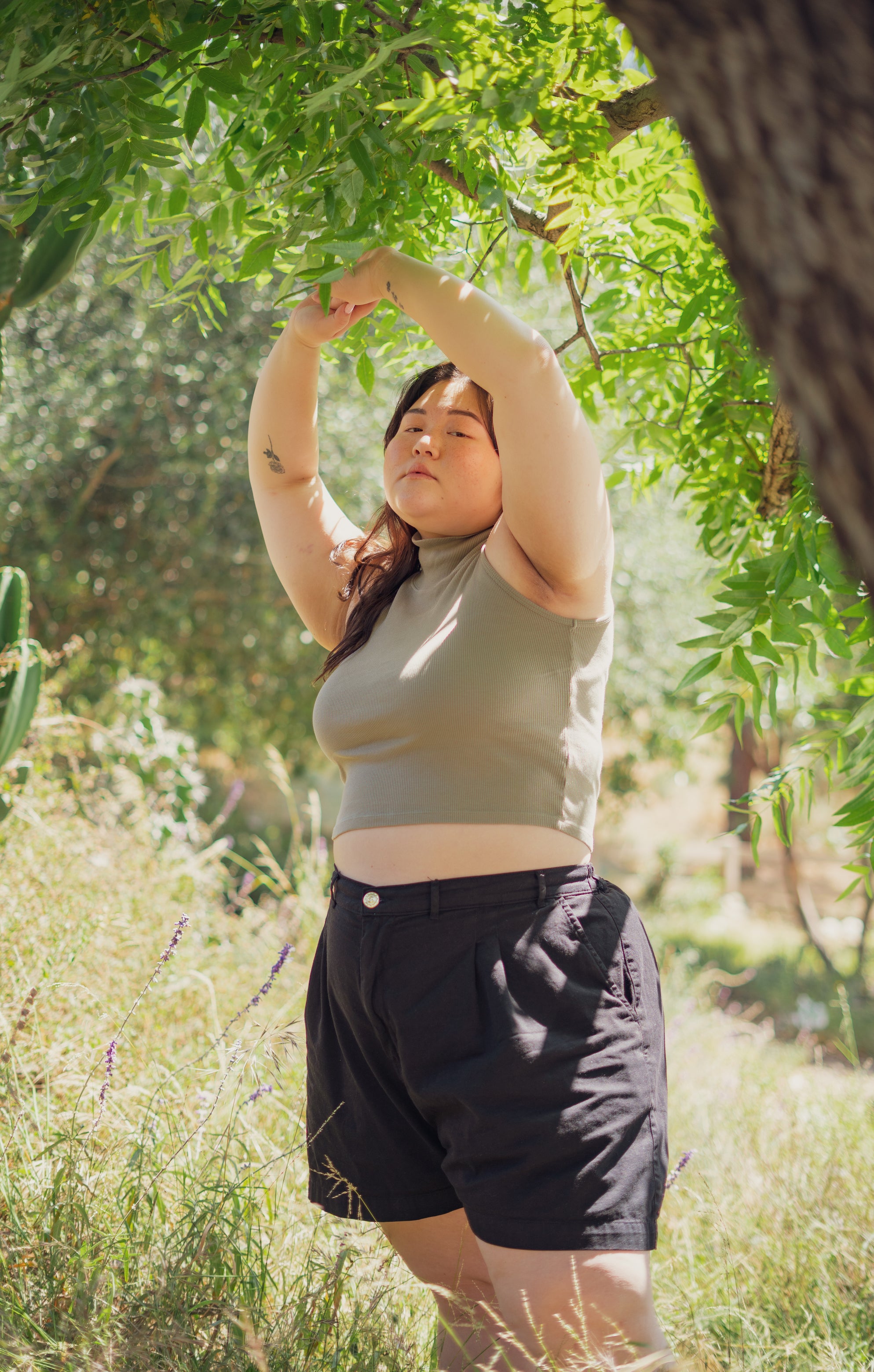 Ashley wearing Sleeveless Essential Turtleneck in Khaki Grey and Trouser Shorts in Basic Black