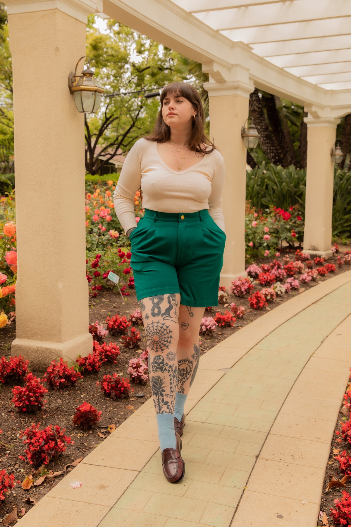 Sydney is wearing Long Sleeve V-Neck Tee in Vintage Off-White and Trouser Shorts in Hunter Green