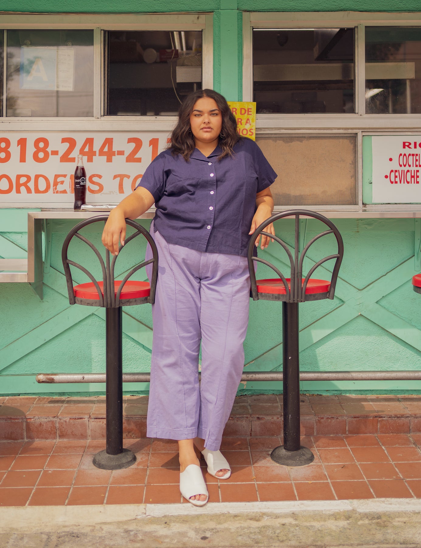 Alicia is wearing Pantry Button-Up in Navy and Western Pants in Faded Grape