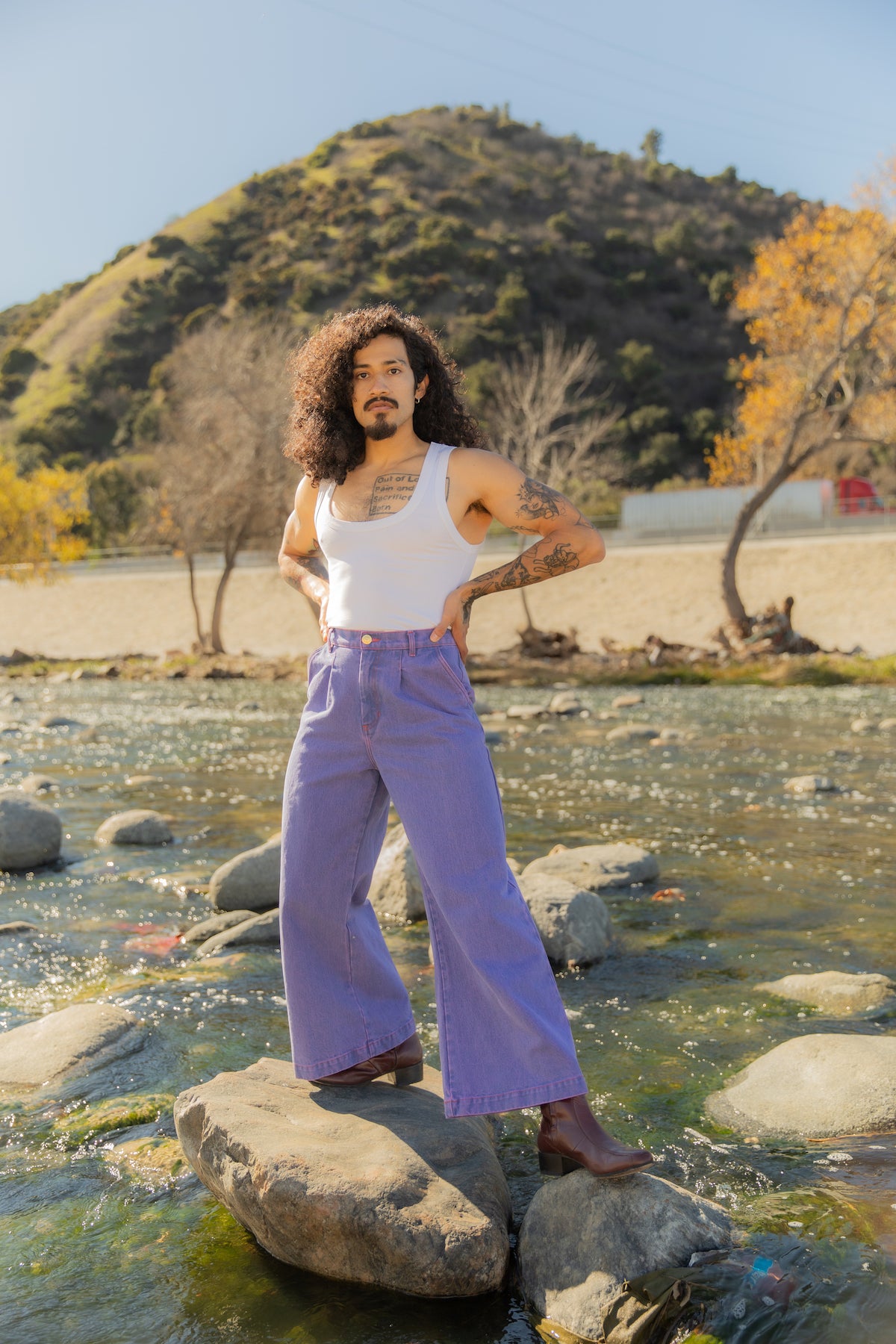 Jesse is wearing Overdyed Wide Leg Trousers in Faded Grape and Cropped Tank Top in Vintage Off-White