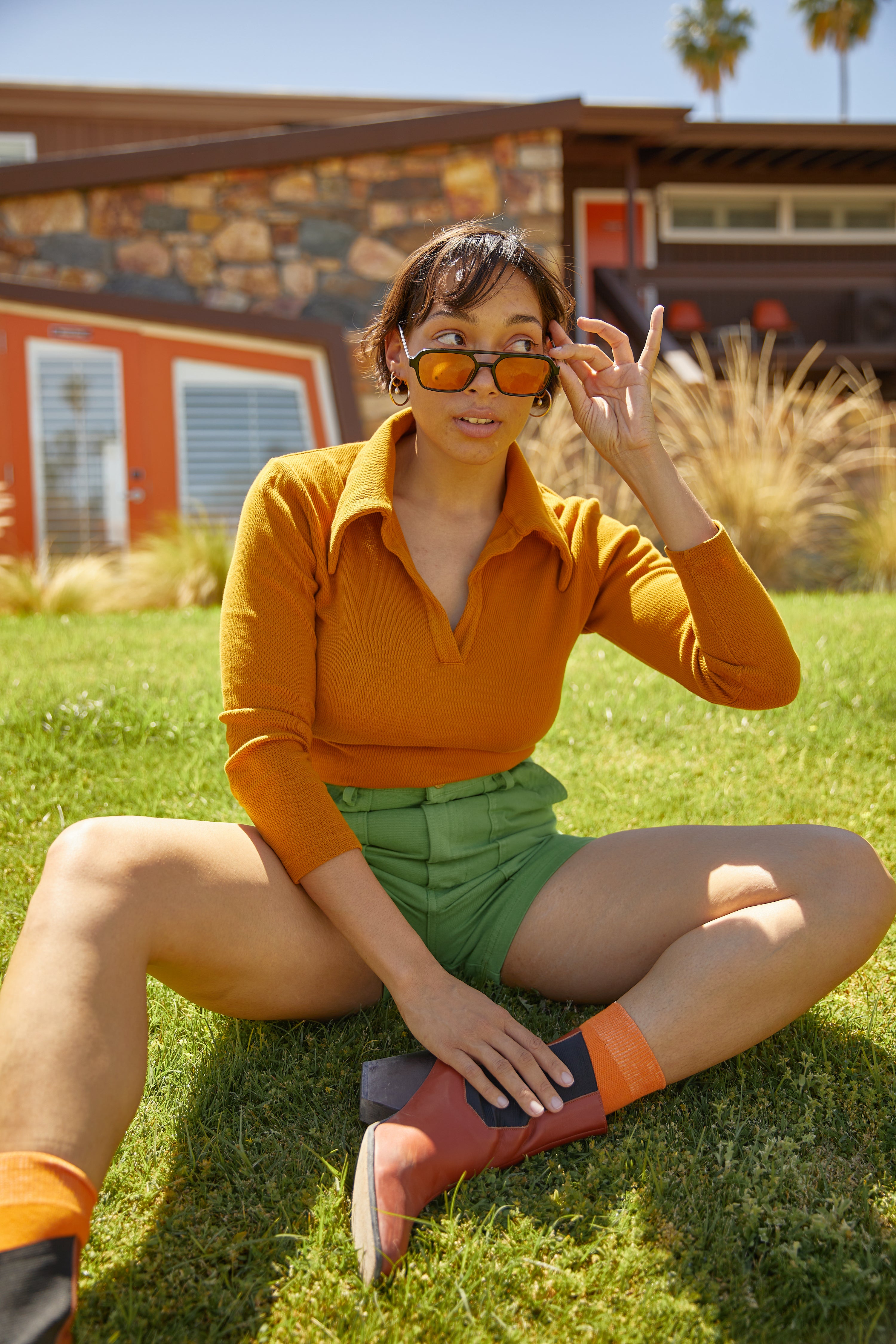 Tiara wearing long sleeve fisherman polo in spicy mustard and work shorts in bright olive