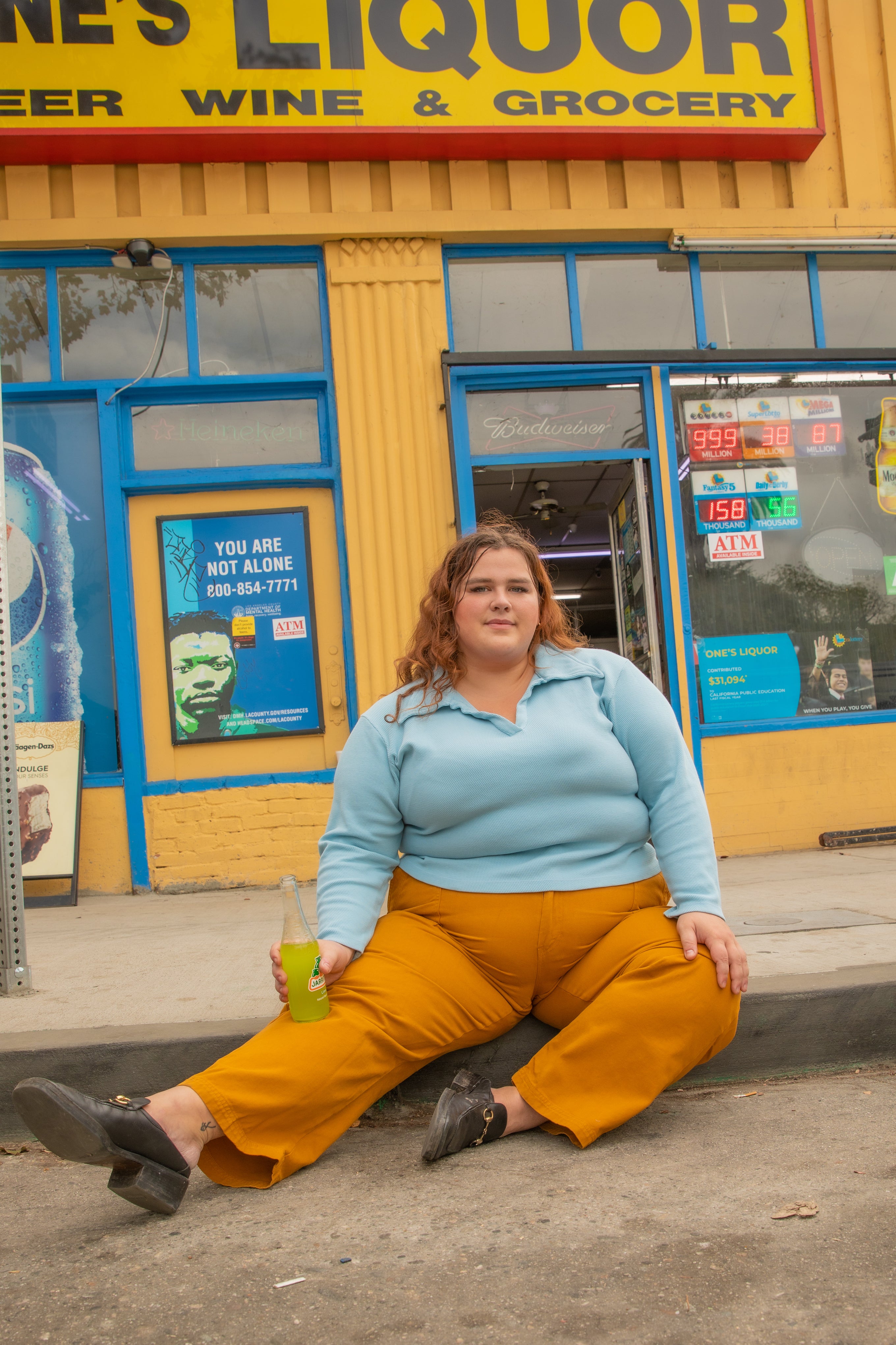 Mara wearing Long Sleeve Fisherman Polo in Baby Blue and Work Pants in Spicy Mustard