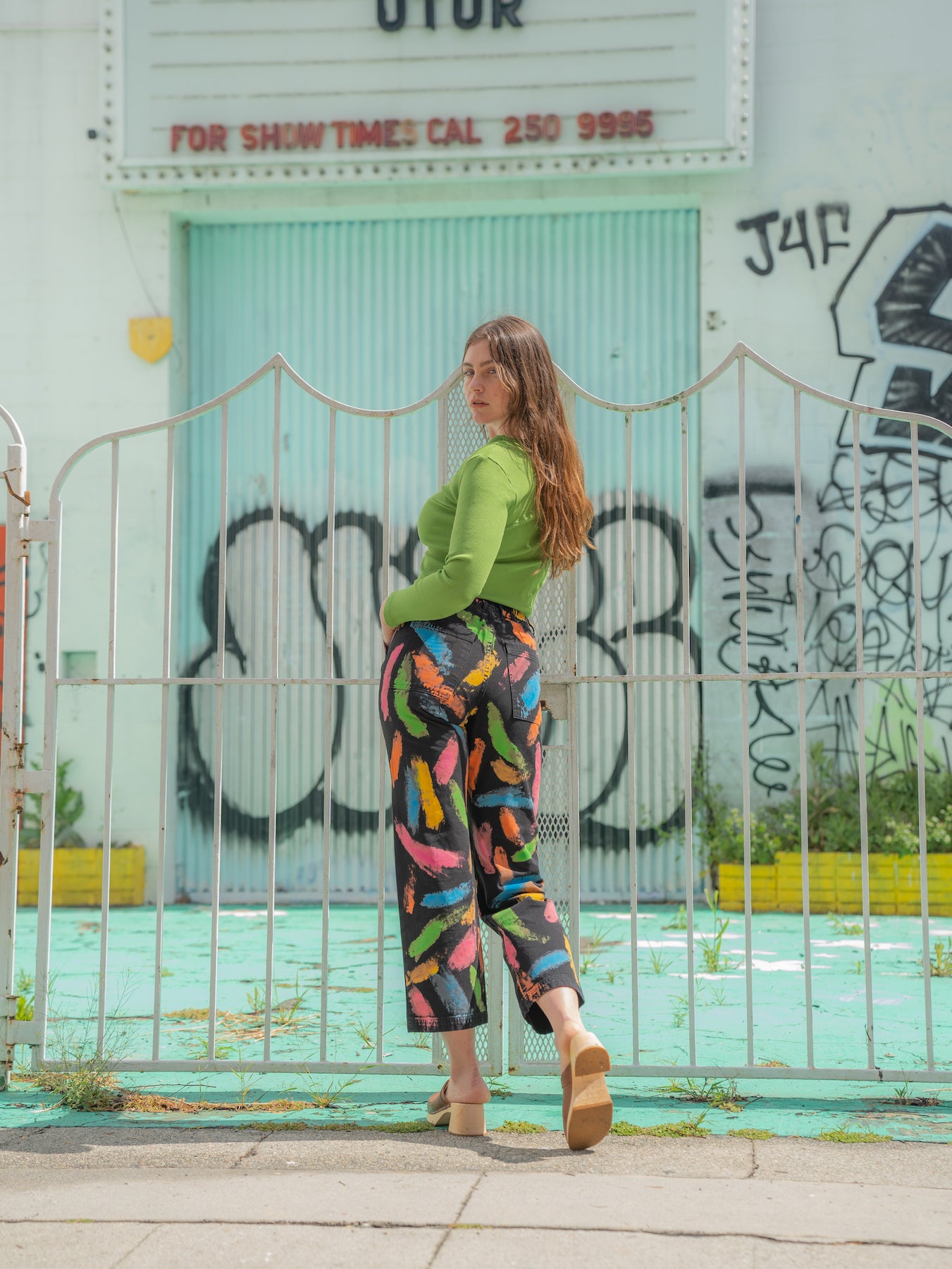 Allison is wearing Paint Stroke Work Pants and Long Sleeve V-Neck Tee in Bright Olive