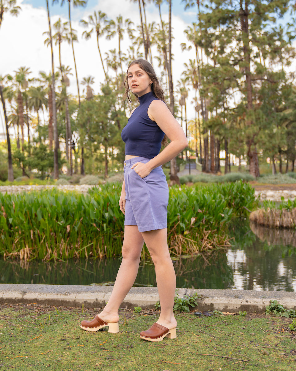 Allison is wearing Sleeveless Essential Turtleneck in Navy Blue and Trouser Shorts in Faded Grape