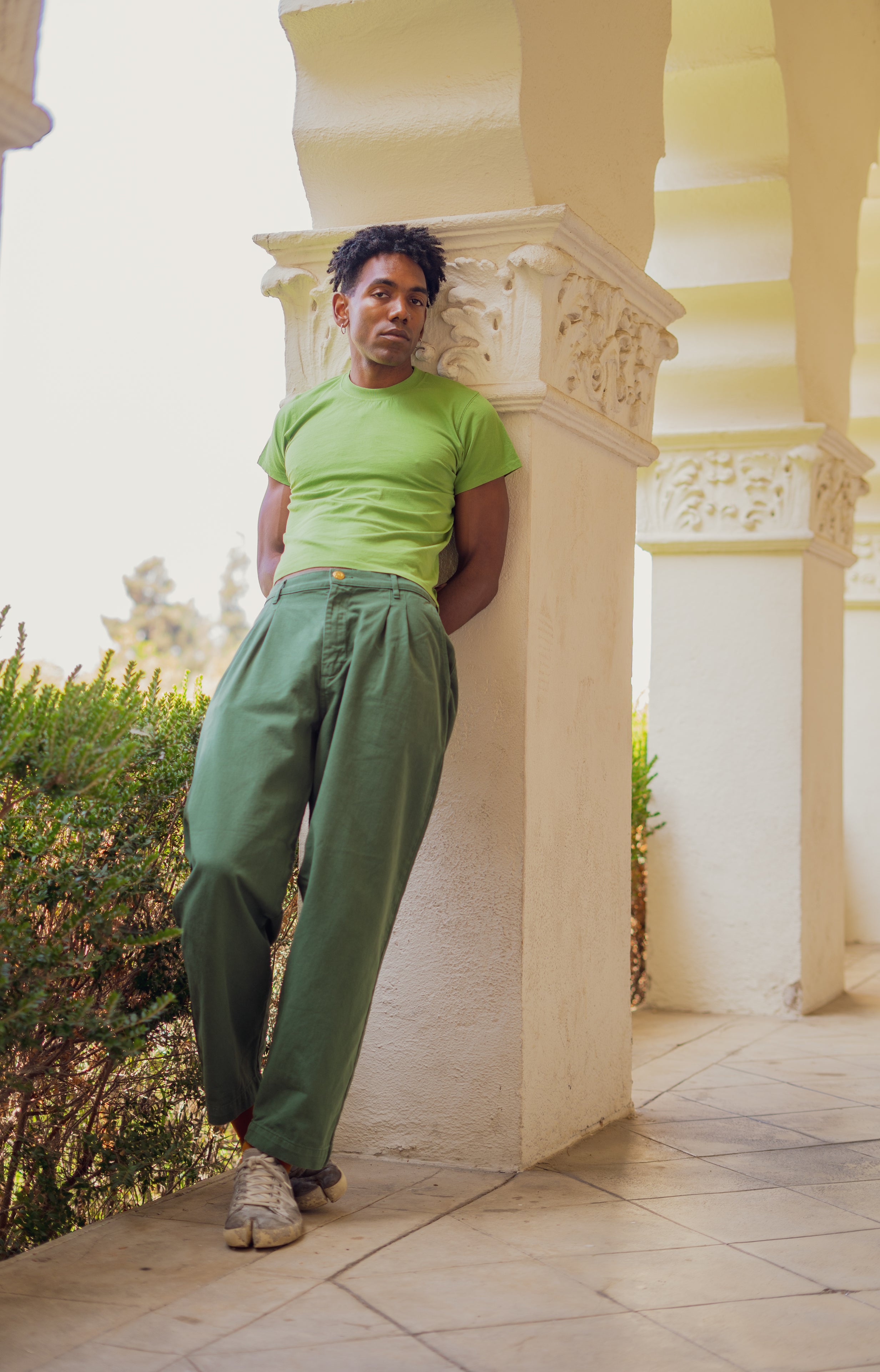 Jerrod wearing Organic Vintage Tee in Bright Olive and Heavyweight Trousers in Dark Emerald Green