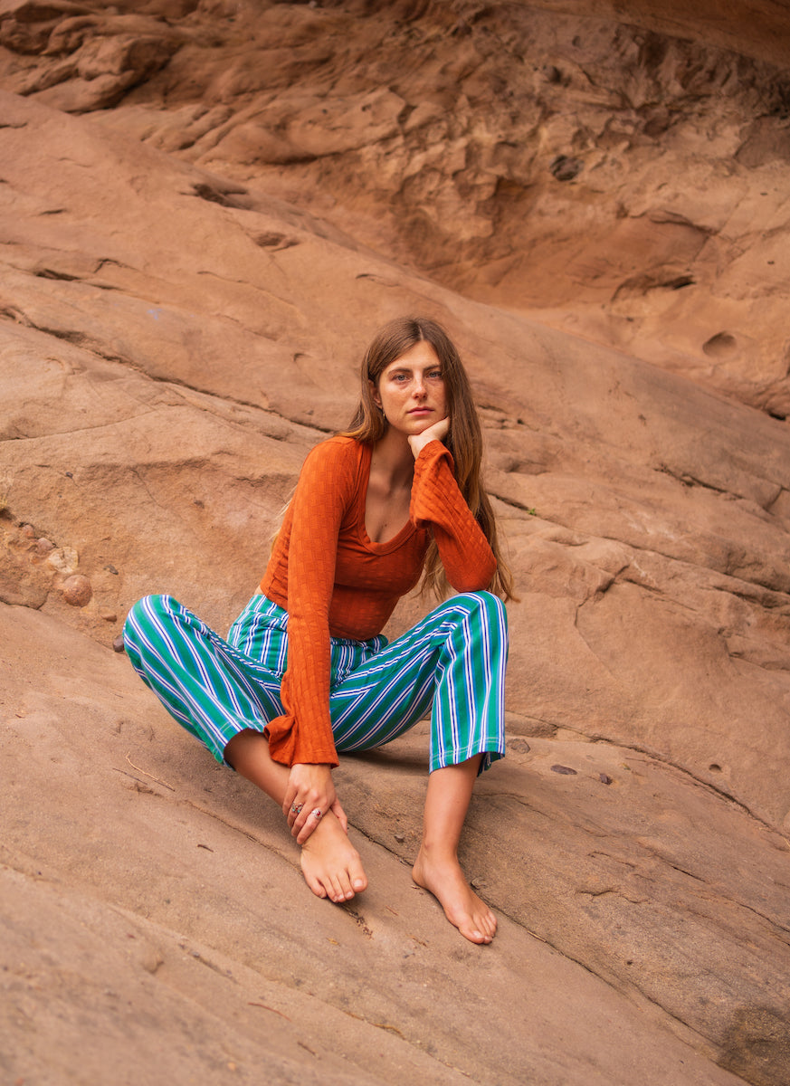 lett is wearing Bell Sleeve Top in Burnt Terracotta and Striped Work Pants in Blue