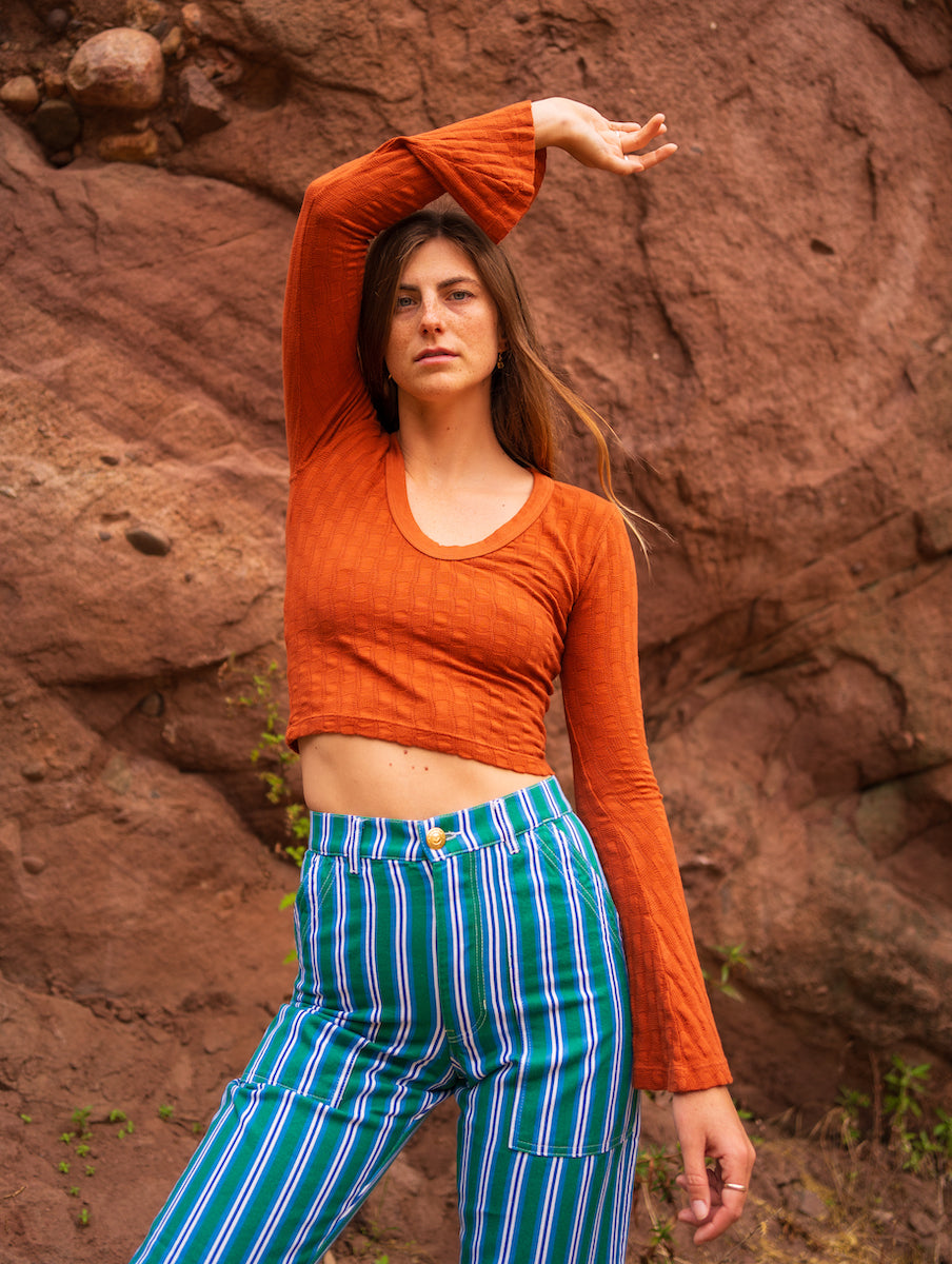 lett is wearing Bell Sleeve Top in Burnt Terracotta and Striped Work Pants in Blue
