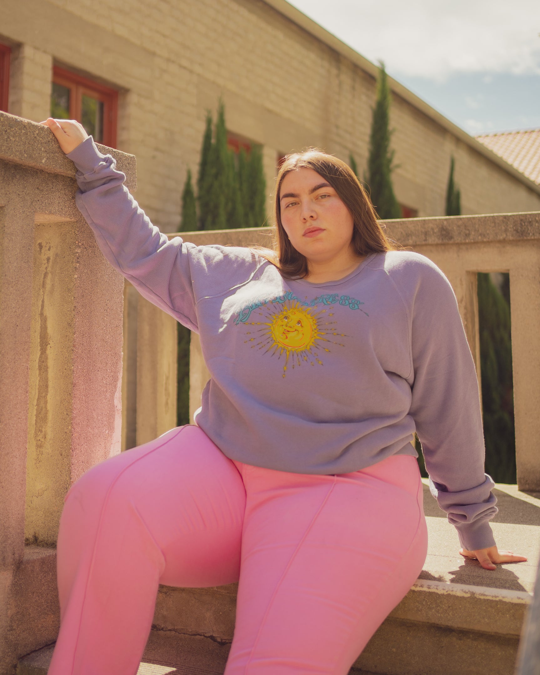 Marielena is wearing Bill Ogden's Sun Baby Crew in Faded Grape and Western Pants in Bubblegum Pink