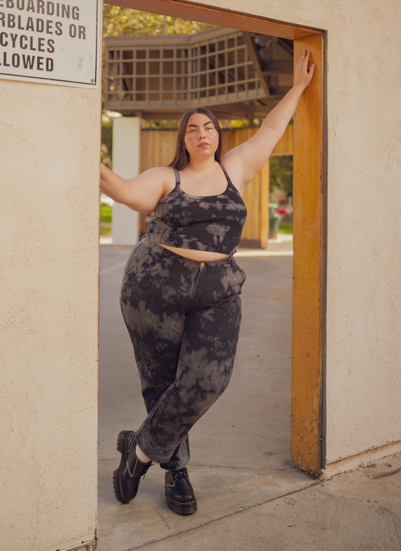 Marielena is wearing Cropped Cami in Black Magic Waters and Black Magic Waters Work Pants