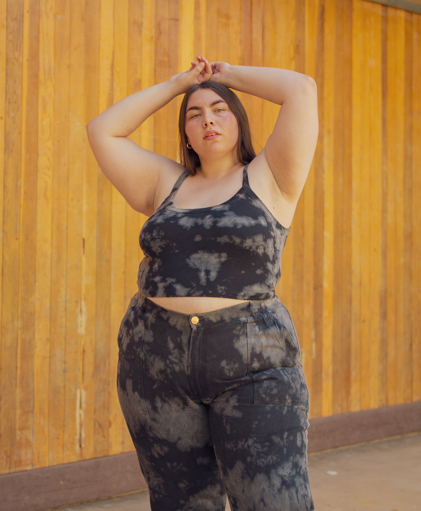 Marielena is wearing Cropped Cami in Black Magic Waters and Black Magic Waters Work Pants