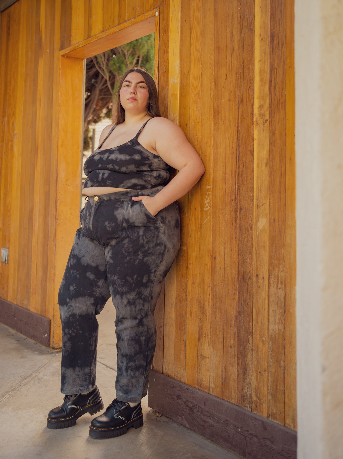 Marielena is wearing Cropped Cami in Black Magic Waters and Black Magic Waters Work Pants