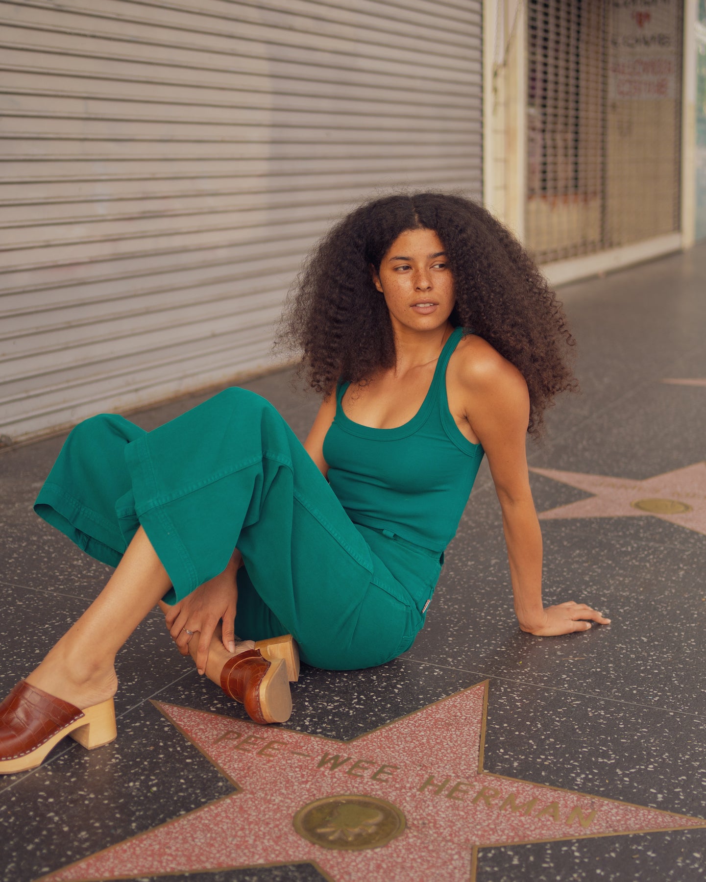 T'ni is wearing Cropped Tank Top in Hunter Green and Bell Bottoms in Hunter Green