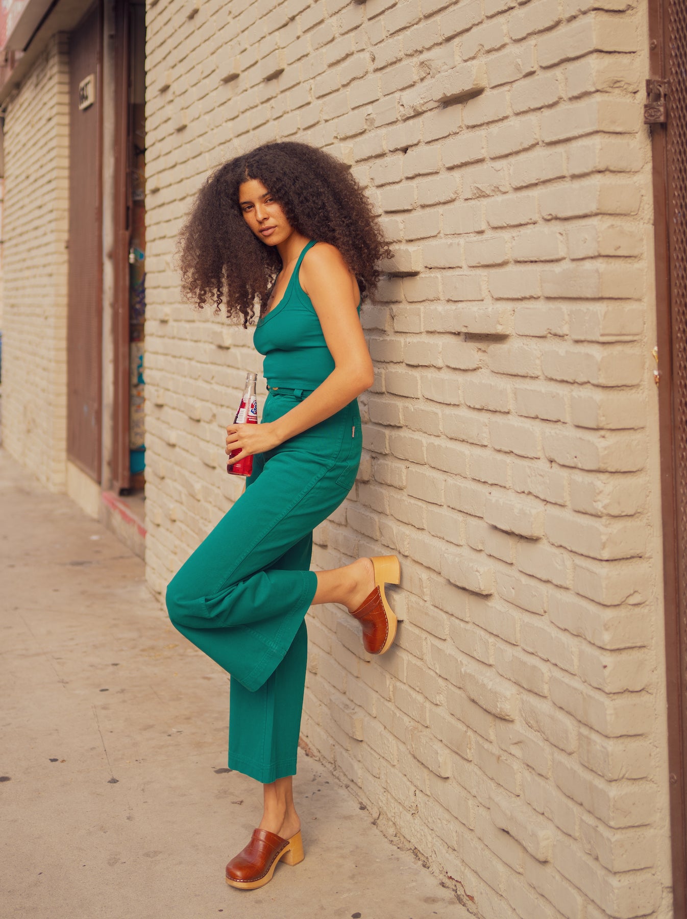 T'ni is wearing Cropped Tank Top in Hunter Green and Bell Bottoms in Hunter Green