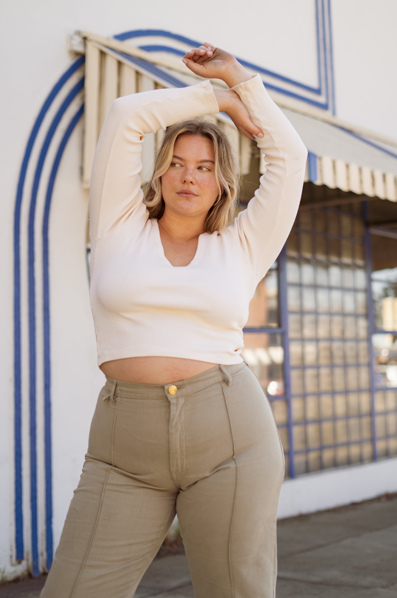 Lish is wearing Long Sleeve V-Neck Tee in Vintage Off-White and Western Pants in Khaki Grey