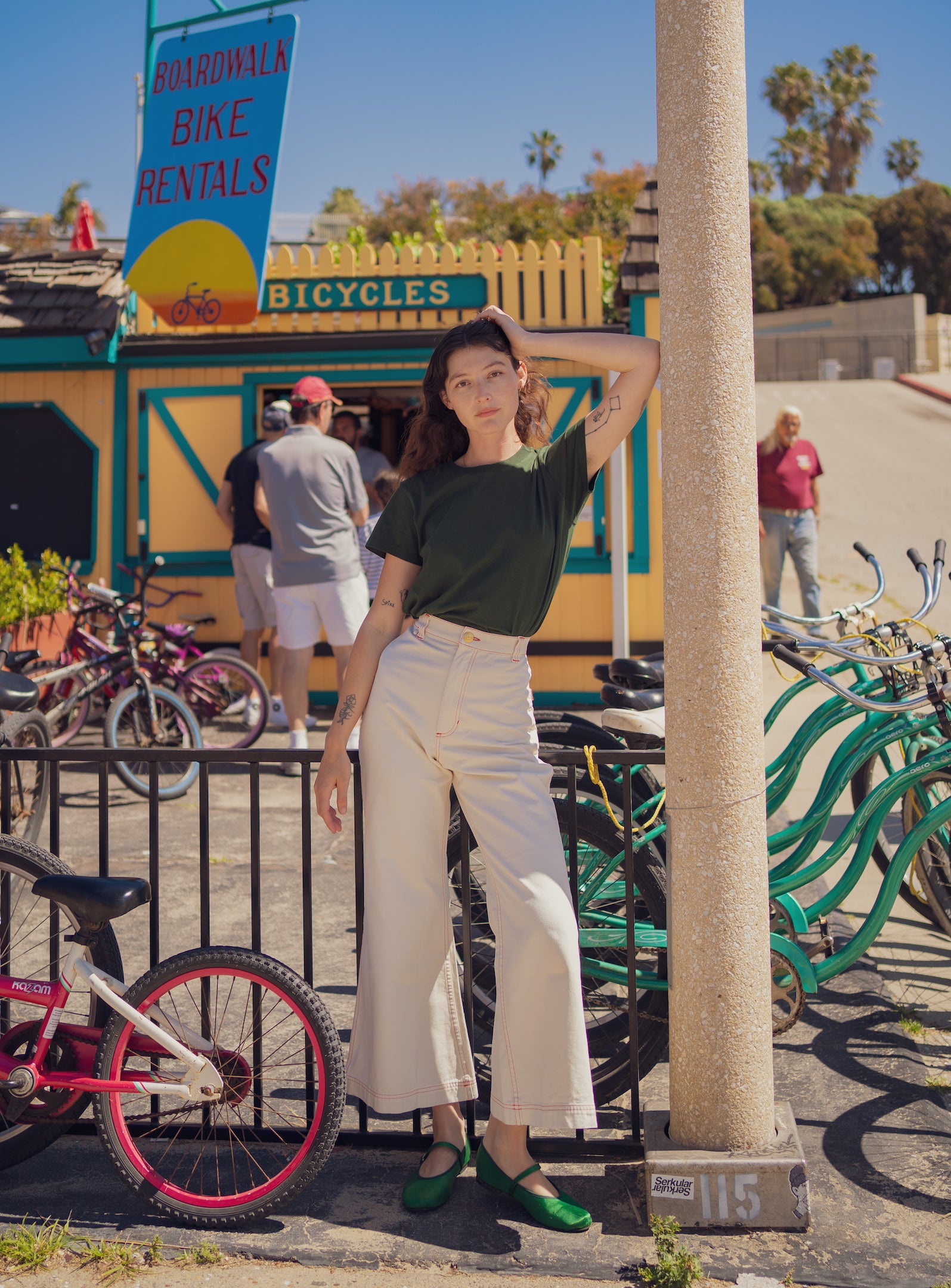 Alexandra Skye is wearing The Organic Vintage Tee in Swamp Green and Bell Bottoms in Vintage Tee Off-White