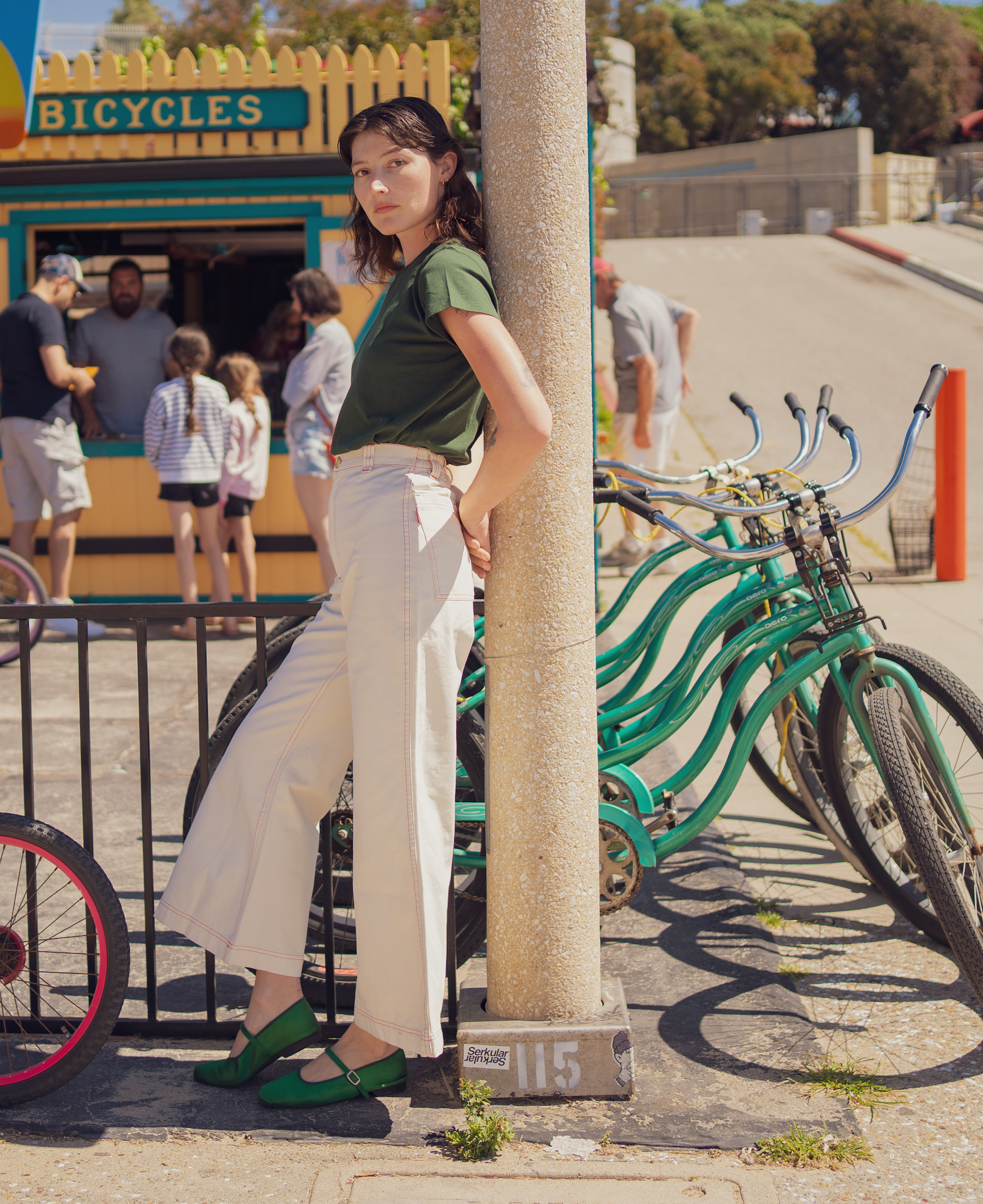 Alexandra Skye is wearing The Organic Vintage Tee in Swamp Green and Bell Bottoms in Vintage Tee Off-White