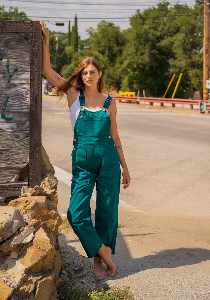 Scarlett is wearing Overalls in Hunter Green and Cropped Cami in Vintage Off-White