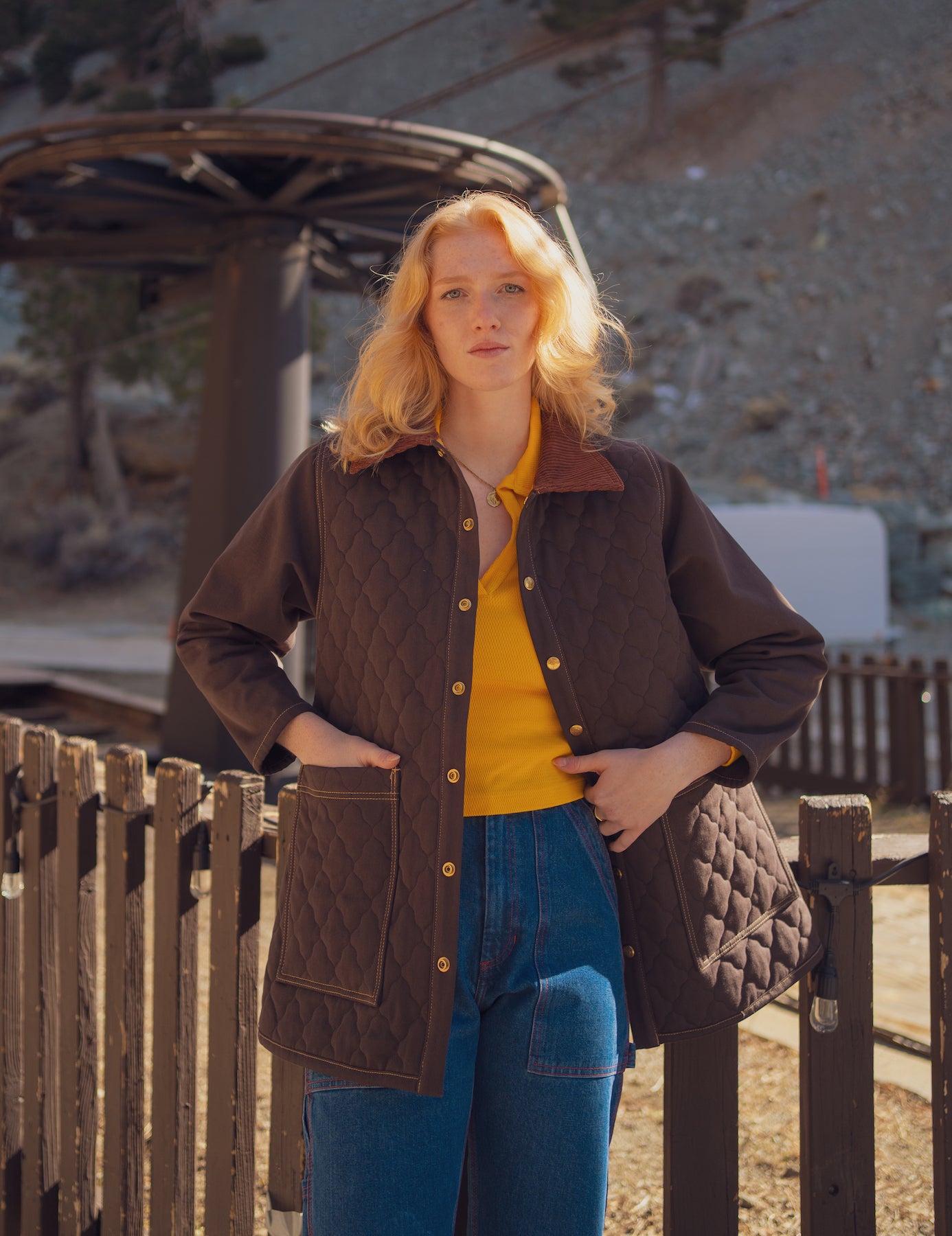 Margaret is wearing Quilted Overcoat in Espresso Brown and Carpenter Jeans in Dark Wash