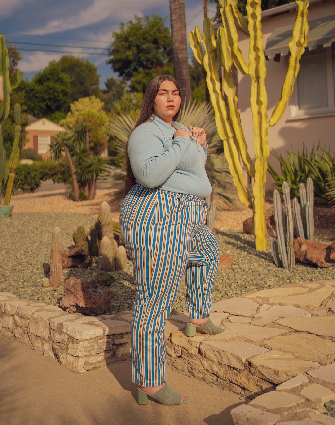 Marielena is wearing Long Sleeve Fisherman Polo in Baby Blue and Stripe Work Pants in Blue/Yellow