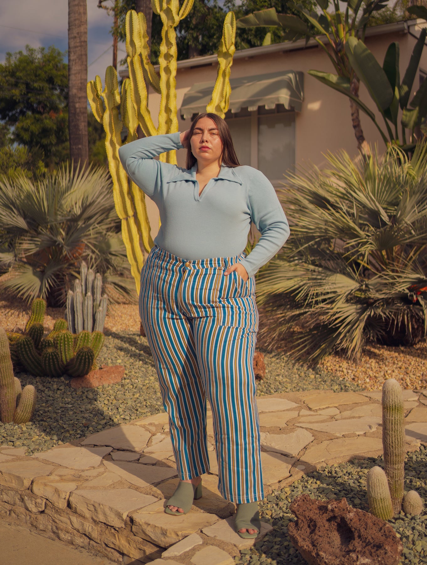 Marielena is wearing Long Sleeve Fisherman Polo in Baby Blue and Stripe Work Pants in Blue/Yellow