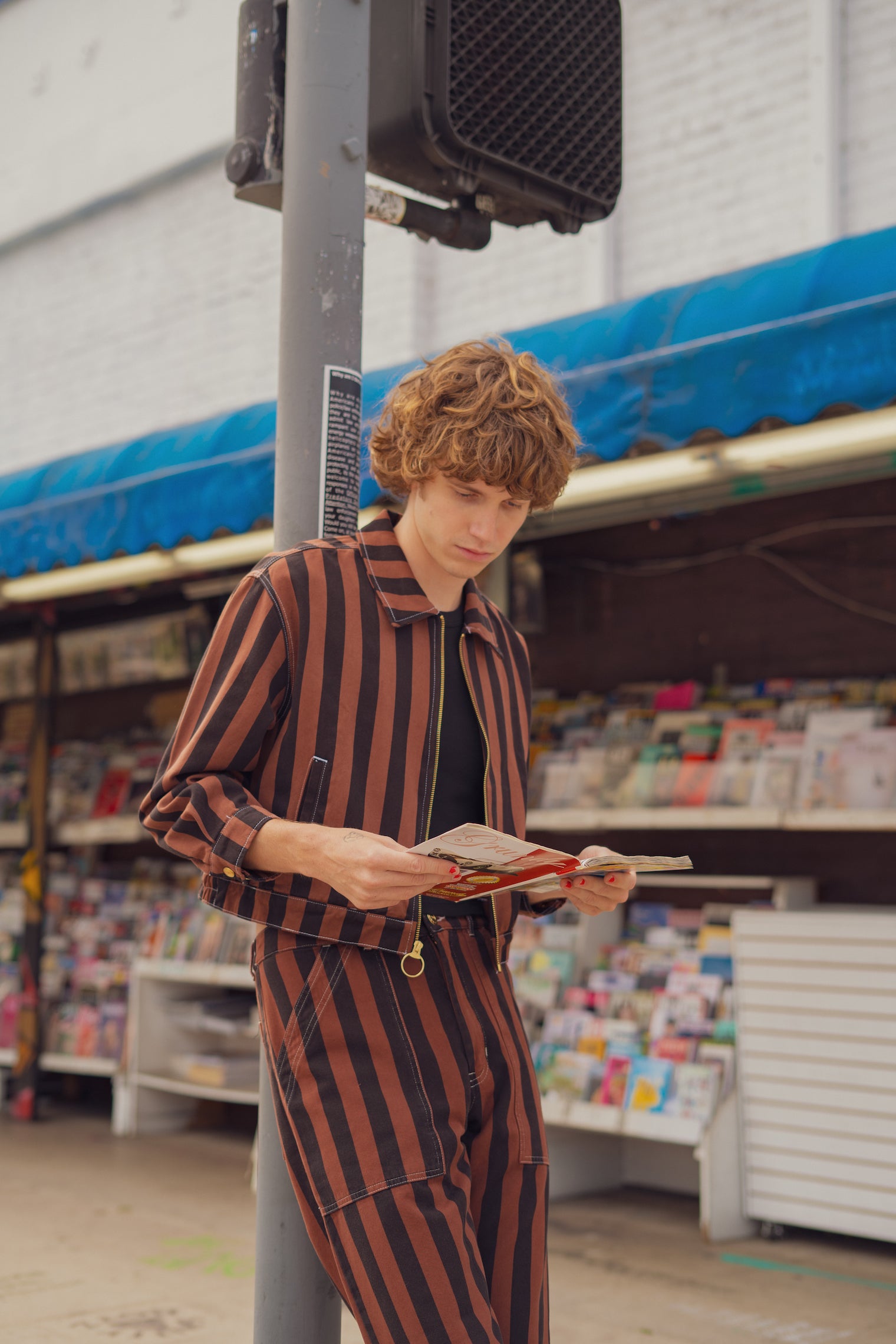 Quinn is wearing Black Stripe Pants in Fudgesicle Brown and Stripe Ricky Jacket in Fudgesicle Brown