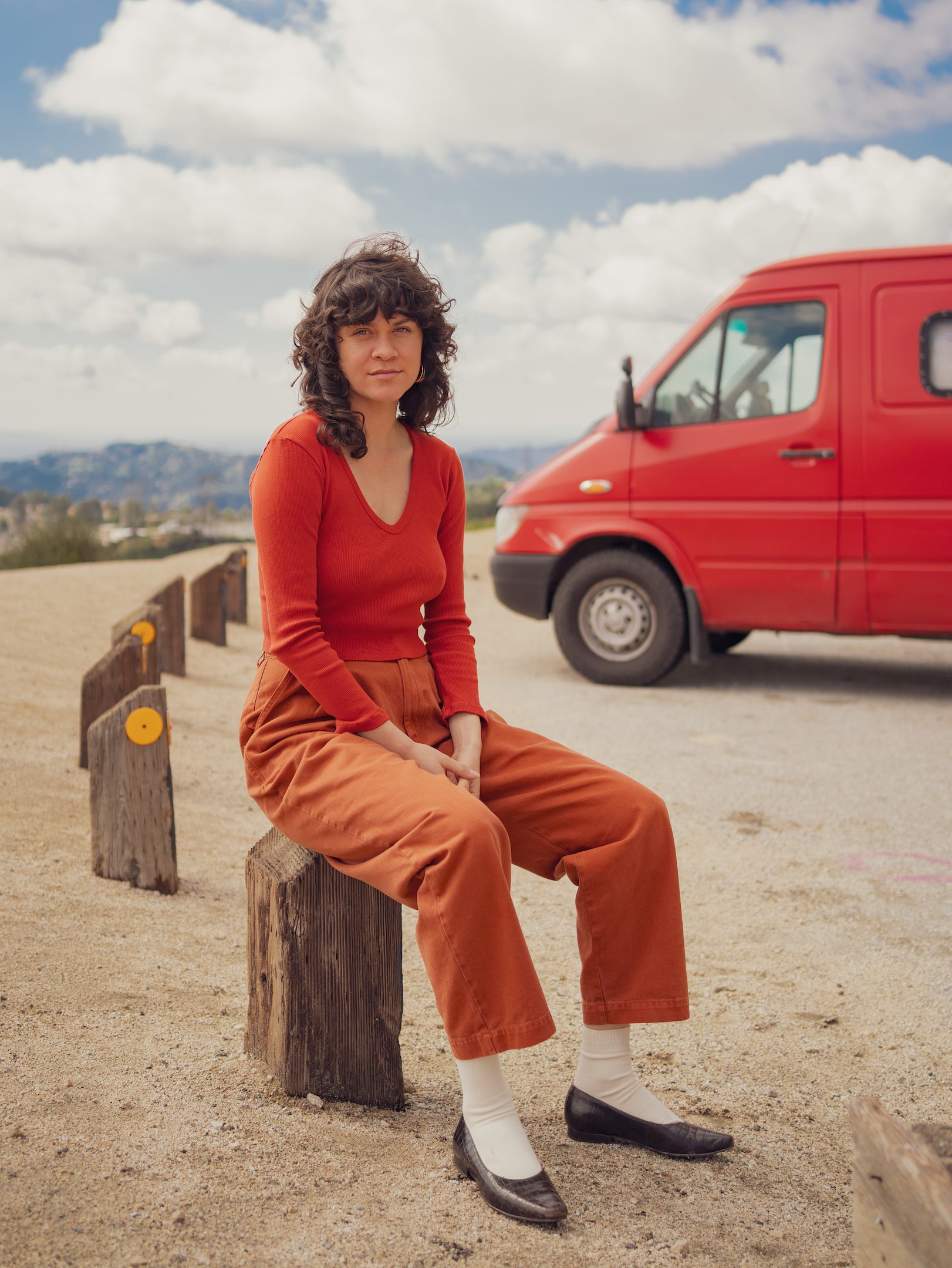 Julia is wearing Long Sleeve V-Neck in Paprika and Heavyweight Trousers in Burnt Terracotta
