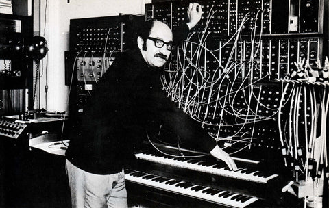 Black and white image of Mort Garson controlling a large, modular synthesizer