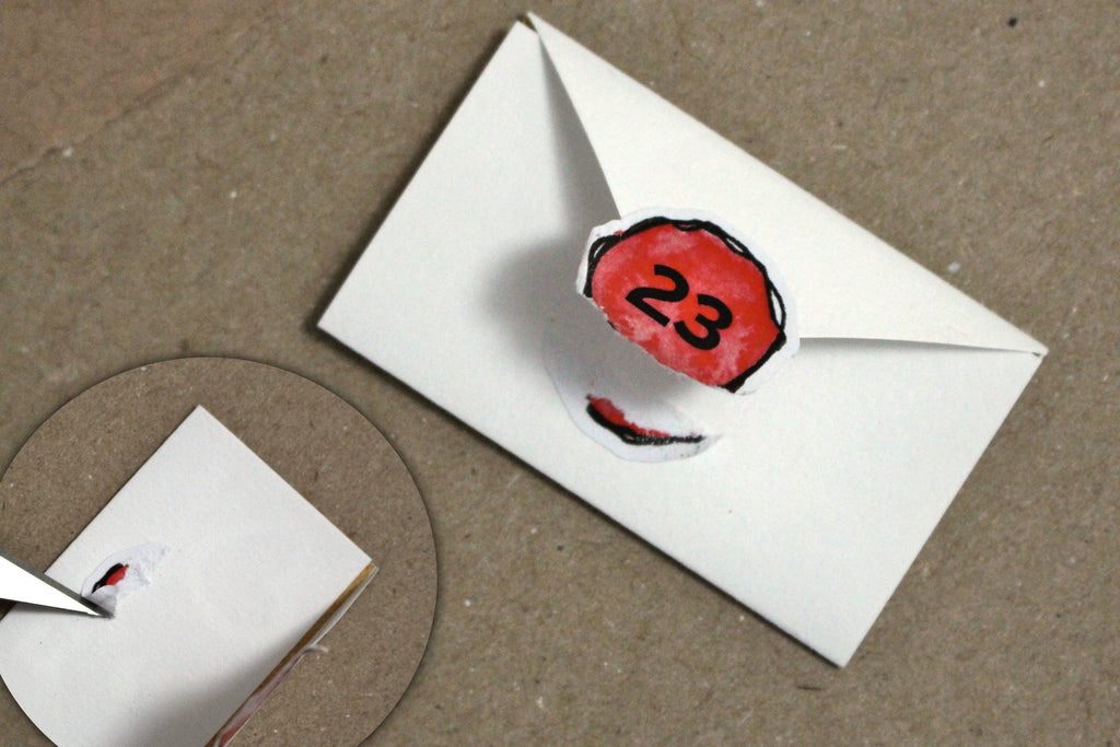 removing a sticker from a mini christmas envelope