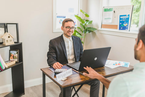 Smiling confidently while engaging with a client, showcasing professional grooming.