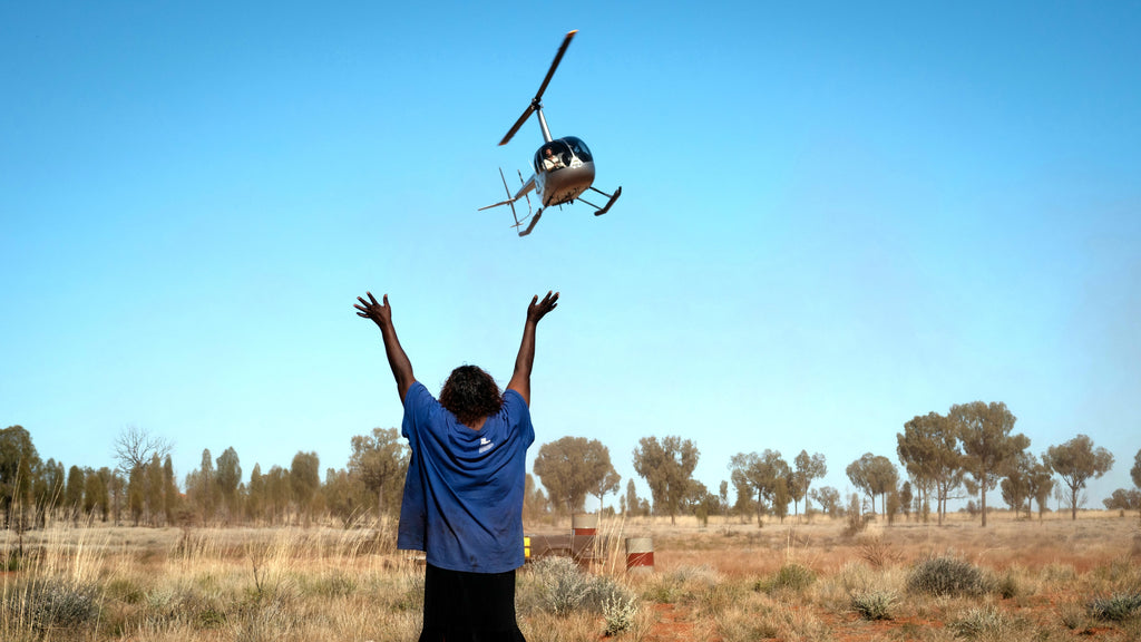 Leonnie Bennett below a helicopter flying towards her