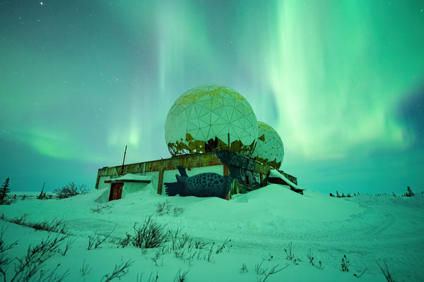 The aurora above an abandoned weather building in Churchill, Manitoba in the winter