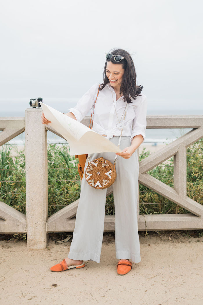 woman wearing orange slides with a casual travel outfit