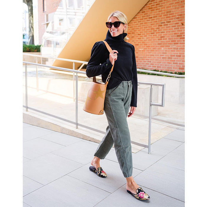 woman wearing sweater, pants, floral-print slides