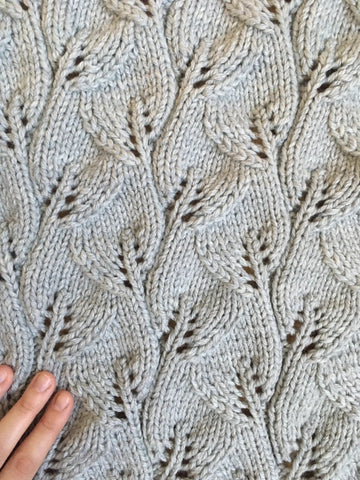 Close up of baby blanket with leaf motif